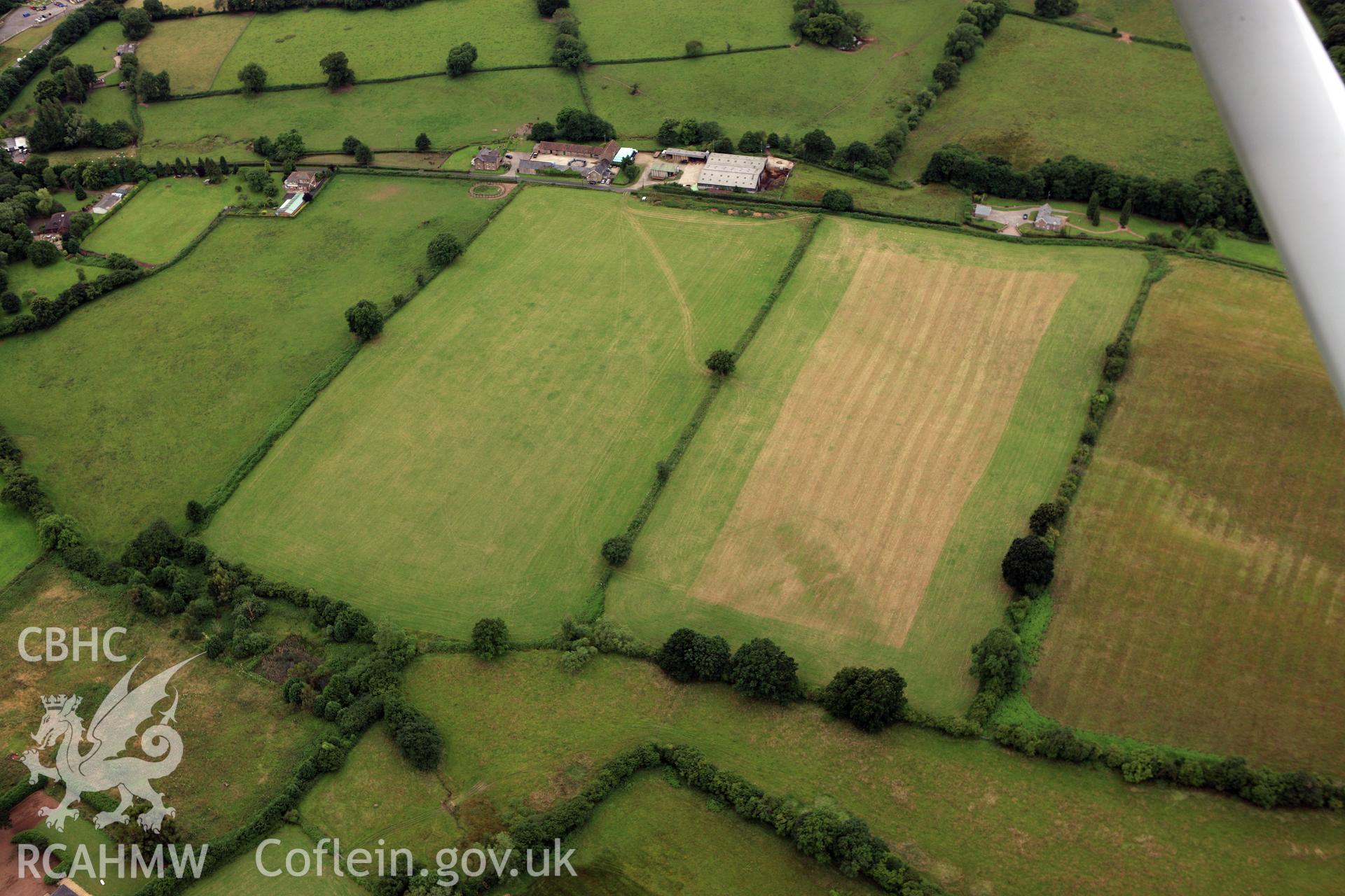 RCAHMW colour oblique aerial photograph showing non - archaeological cropmarks. Taken on 09 July 2009 by Toby Driver