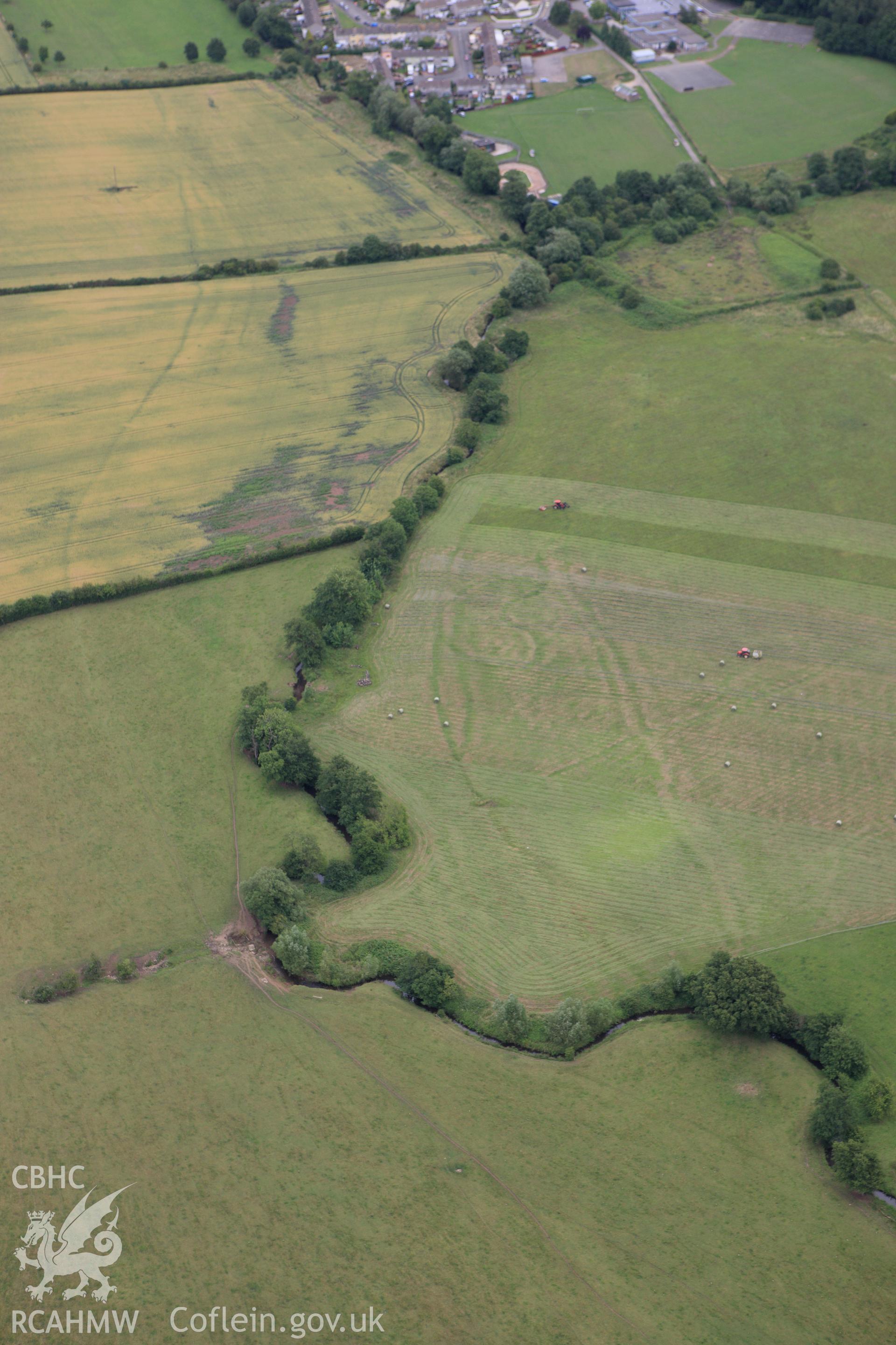 RCAHMW colour oblique aerial photograph of Monks Ditch showing cropmarks of strip field systems. Taken on 09 July 2009 by Toby Driver