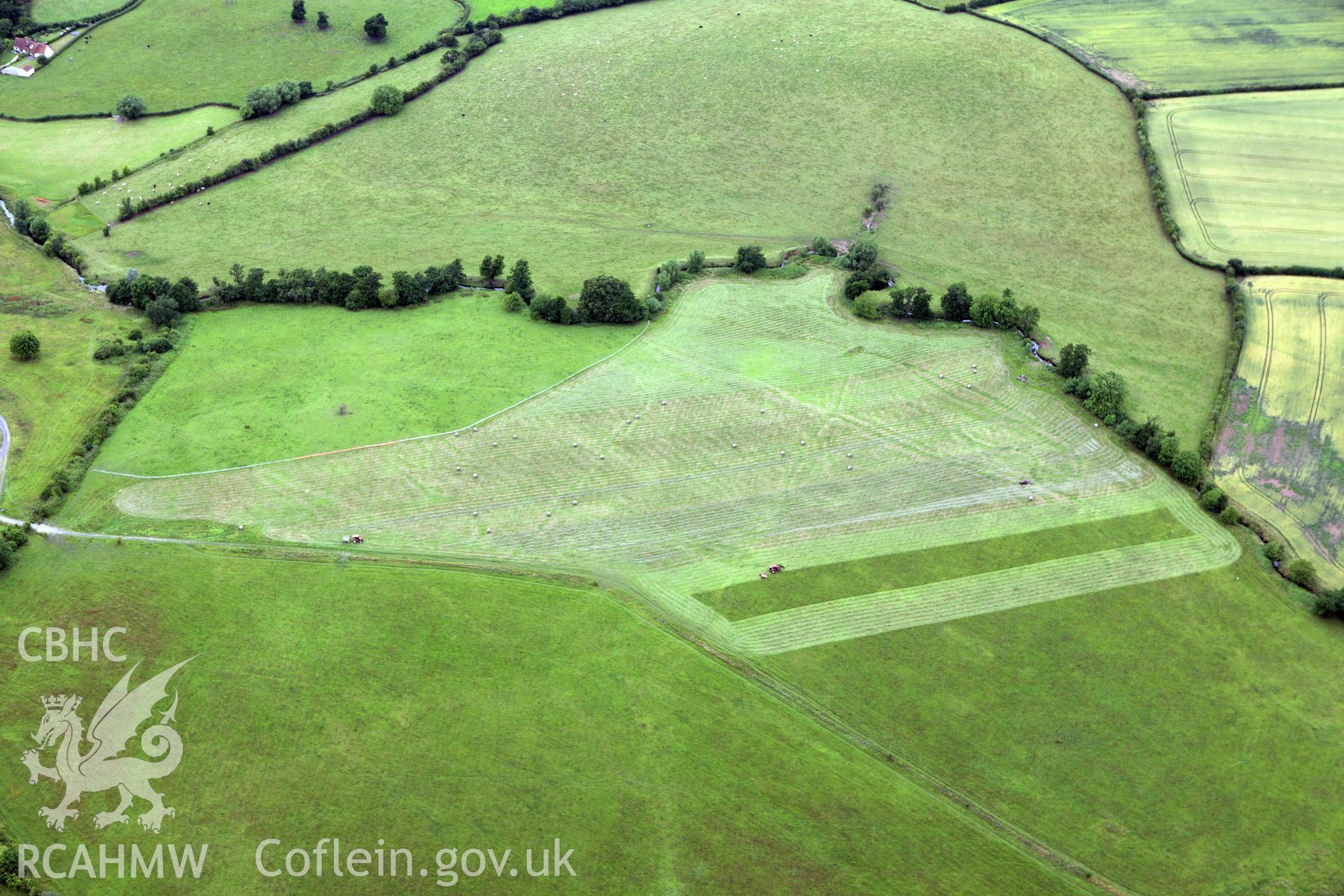RCAHMW colour oblique aerial photograph of Monks Ditch showing cropmarks of strip field systems. Taken on 09 July 2009 by Toby Driver