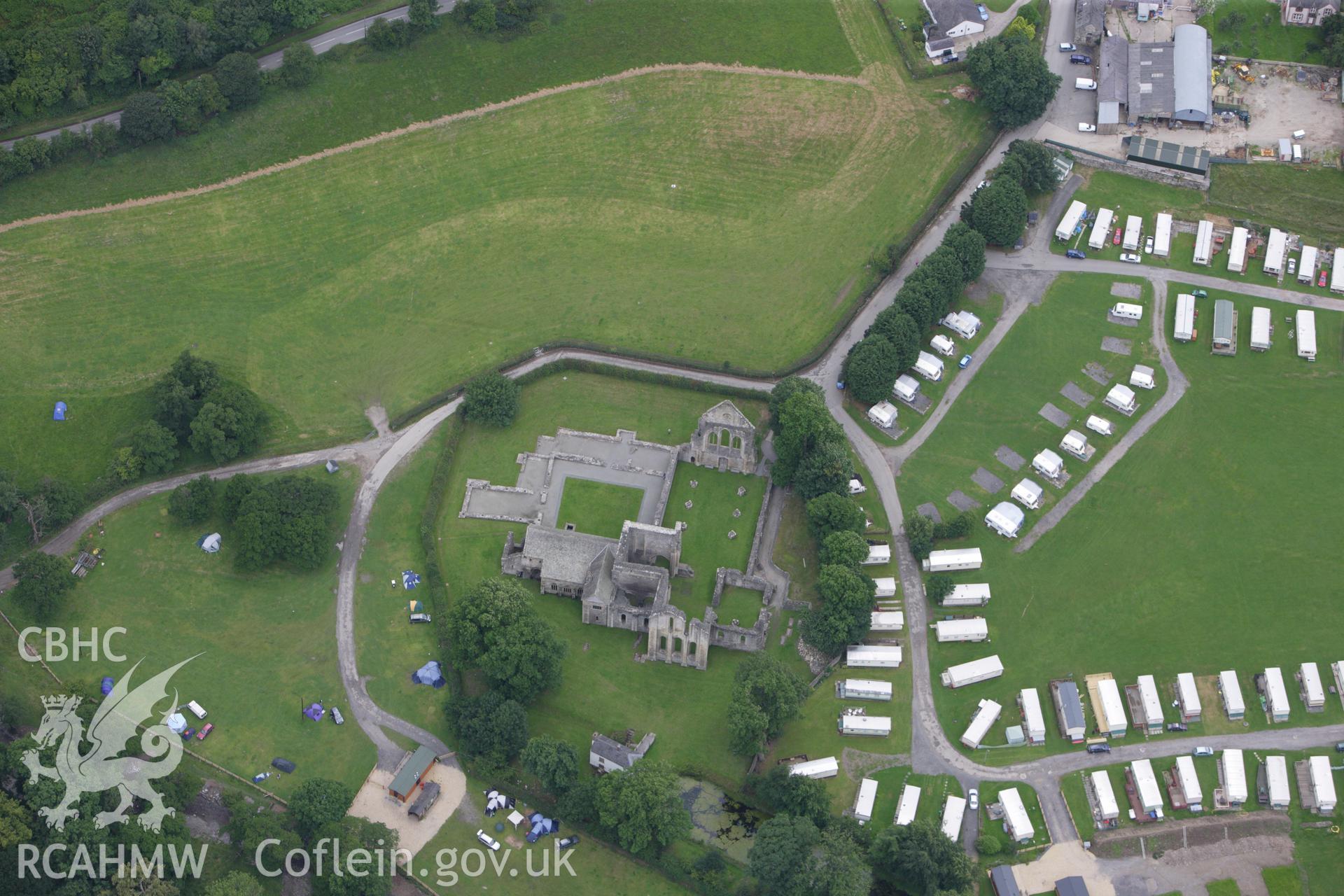 RCAHMW colour oblique aerial photograph of Valle Crucis Abbey. Taken on 08 July 2009 by Toby Driver