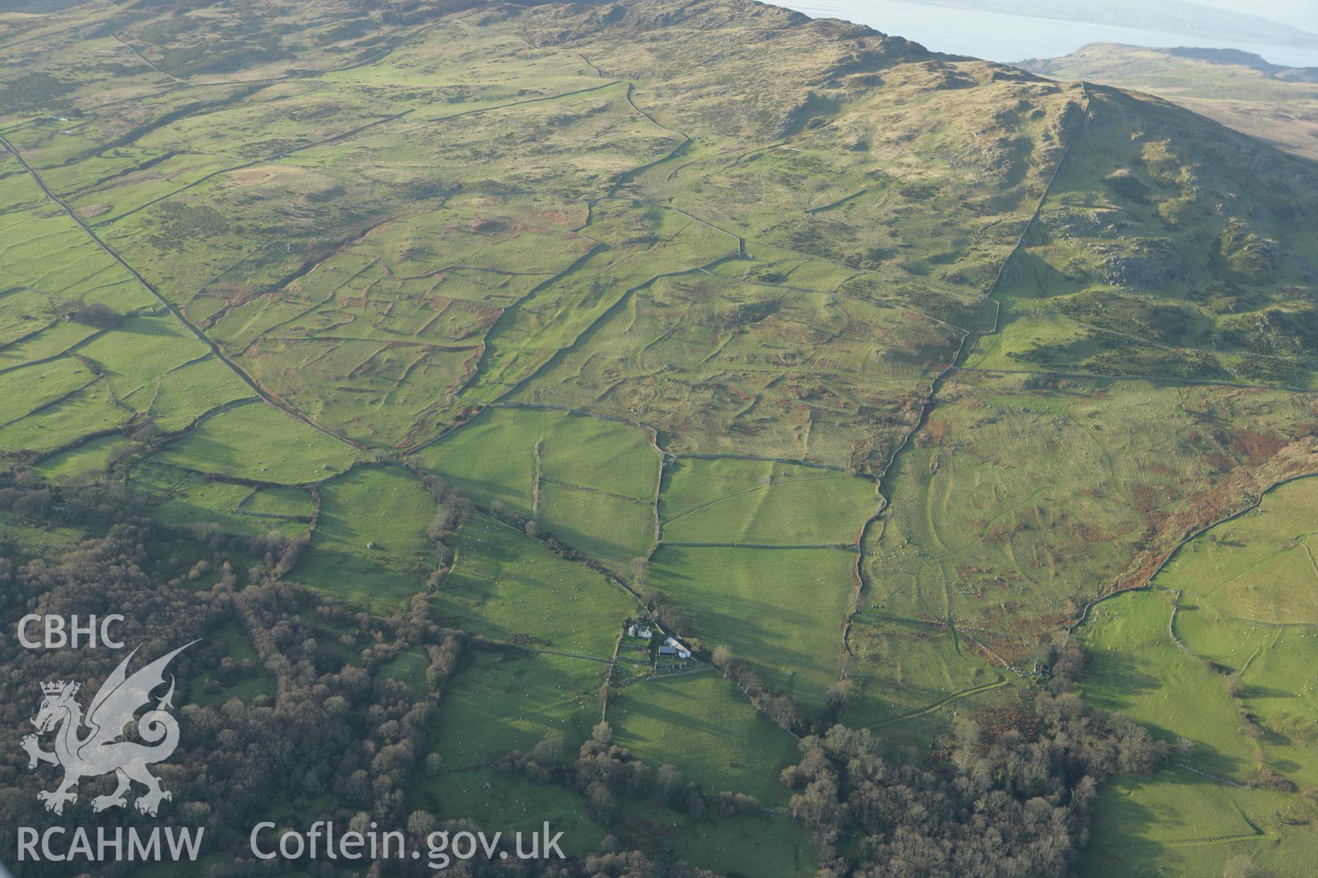 RCAHMW colour oblique aerial photograph of Maen-y-Bardd Settlement and field systems, in andscape from south-east Taken on 10 December 2009 by Toby Driver