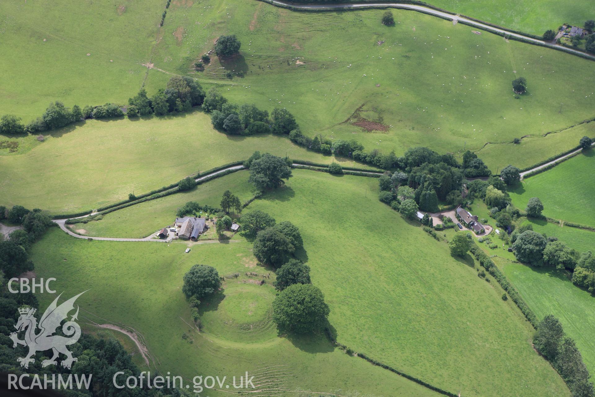 RCAHMW colour oblique aerial photograph of Long Hill Enclosure. Taken on 08 July 2009 by Toby Driver