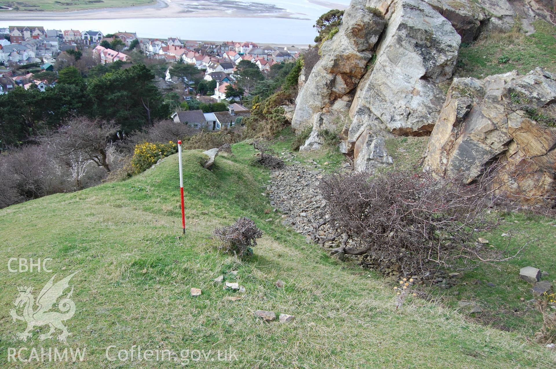Digital photograph from an archaeological assessment of Deganwy Castle, carried out by Gwynedd Archaeological Trust, 2009. Quarry below cliff on S side of donjon.