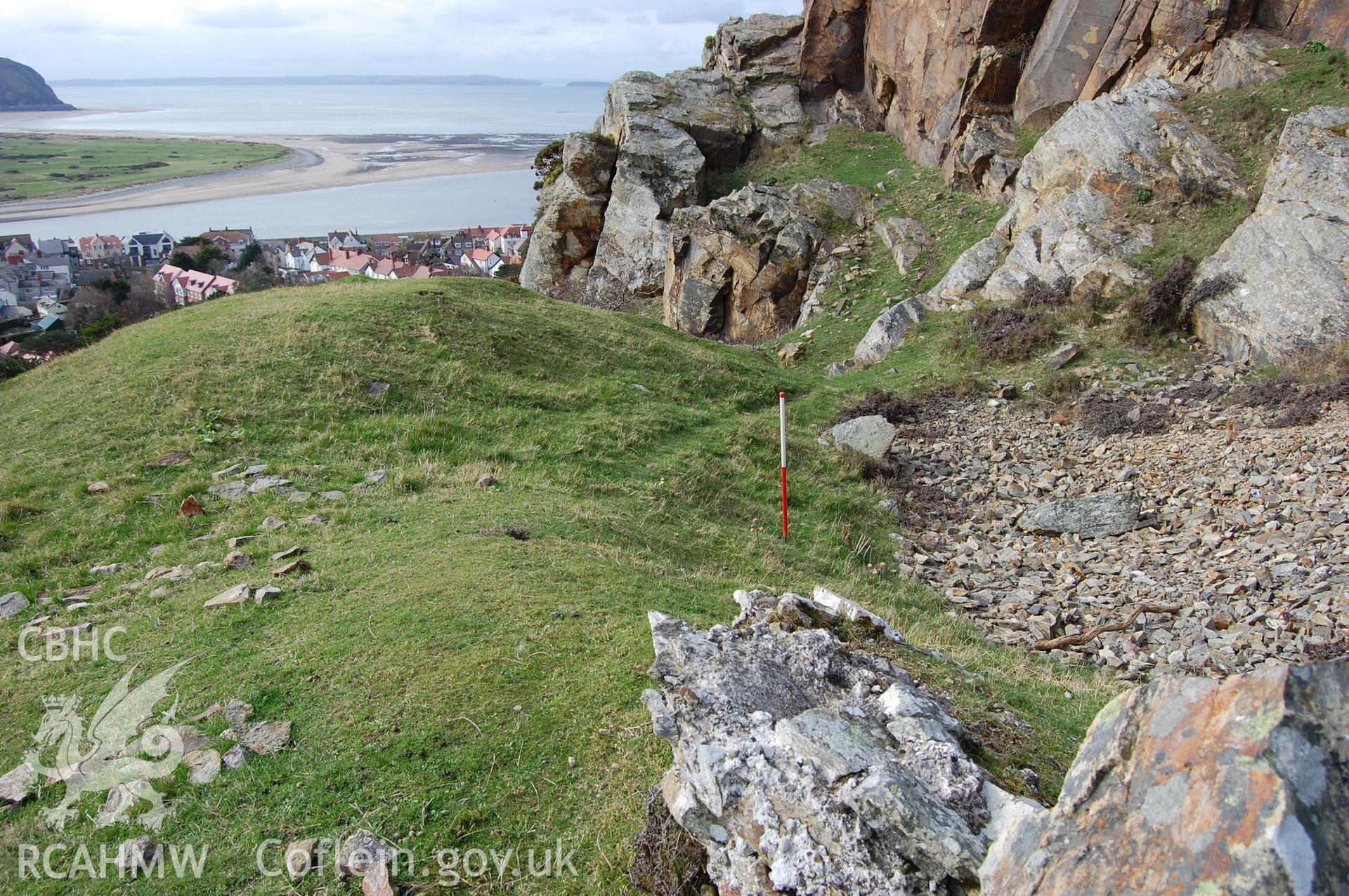 Digital photograph from an archaeological assessment of Deganwy Castle, carried out by Gwynedd Archaeological Trust, 2009. Quarry below cliff on South side of donjon.