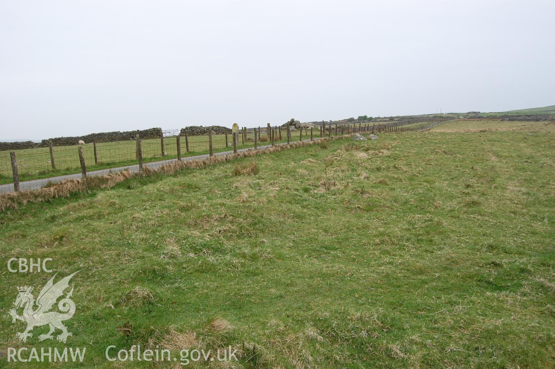 Digitial photograph of line of view down field 8100 showing proximity of standing stone, from a Gwynedd Archaeological Trust archaeological assessment of a field to the rear of Capel En-gedi, Rhiwgoch, near Harlech.