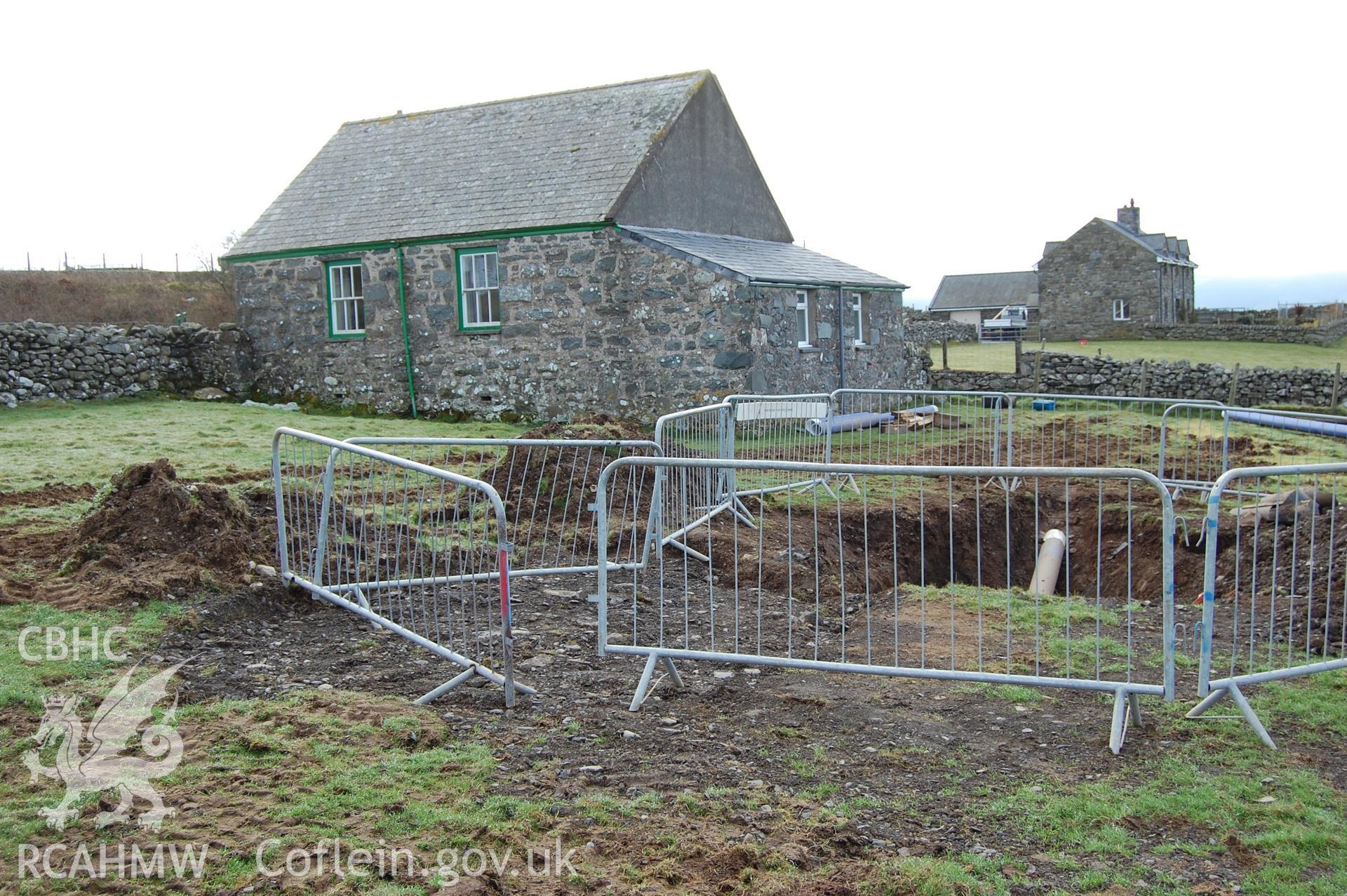 Digitial photograph of pipe bursting hole, from a Gwynedd Archaeological Trust archaeological assessment of a field to the rear of Capel En-gedi, Rhiwgoch, near Harlech.