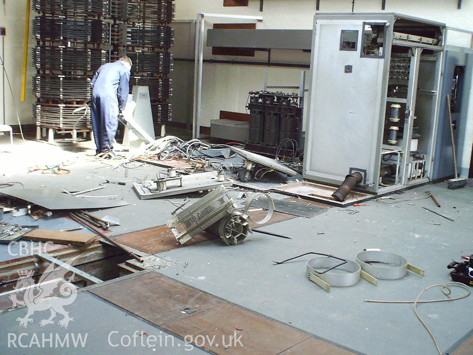 Colour digital photograph of equipment being dismantled.
