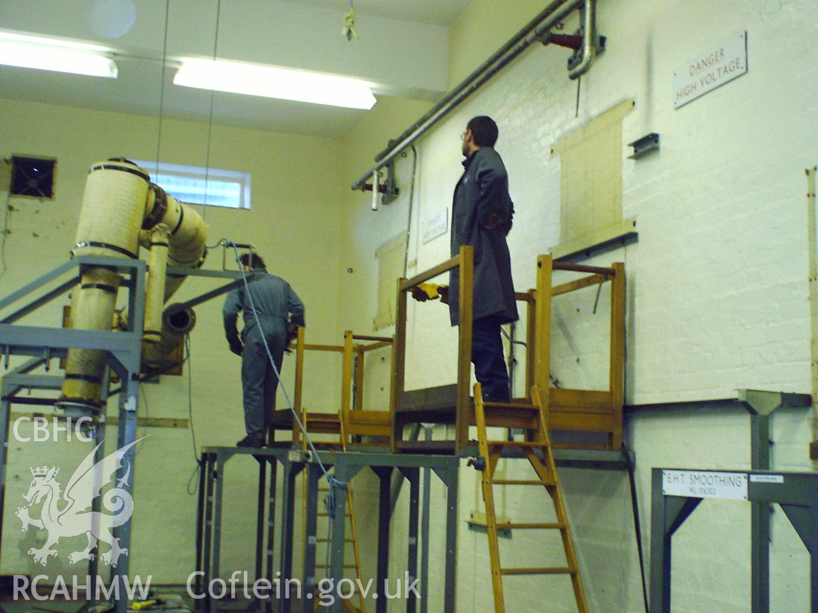Colour digital photograph of equipment being dismantled.