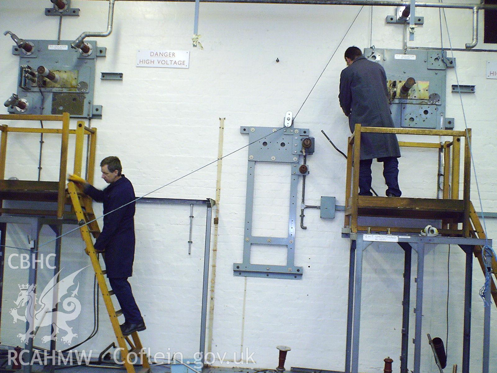 Colour digital photograph of men working at the radio station.
