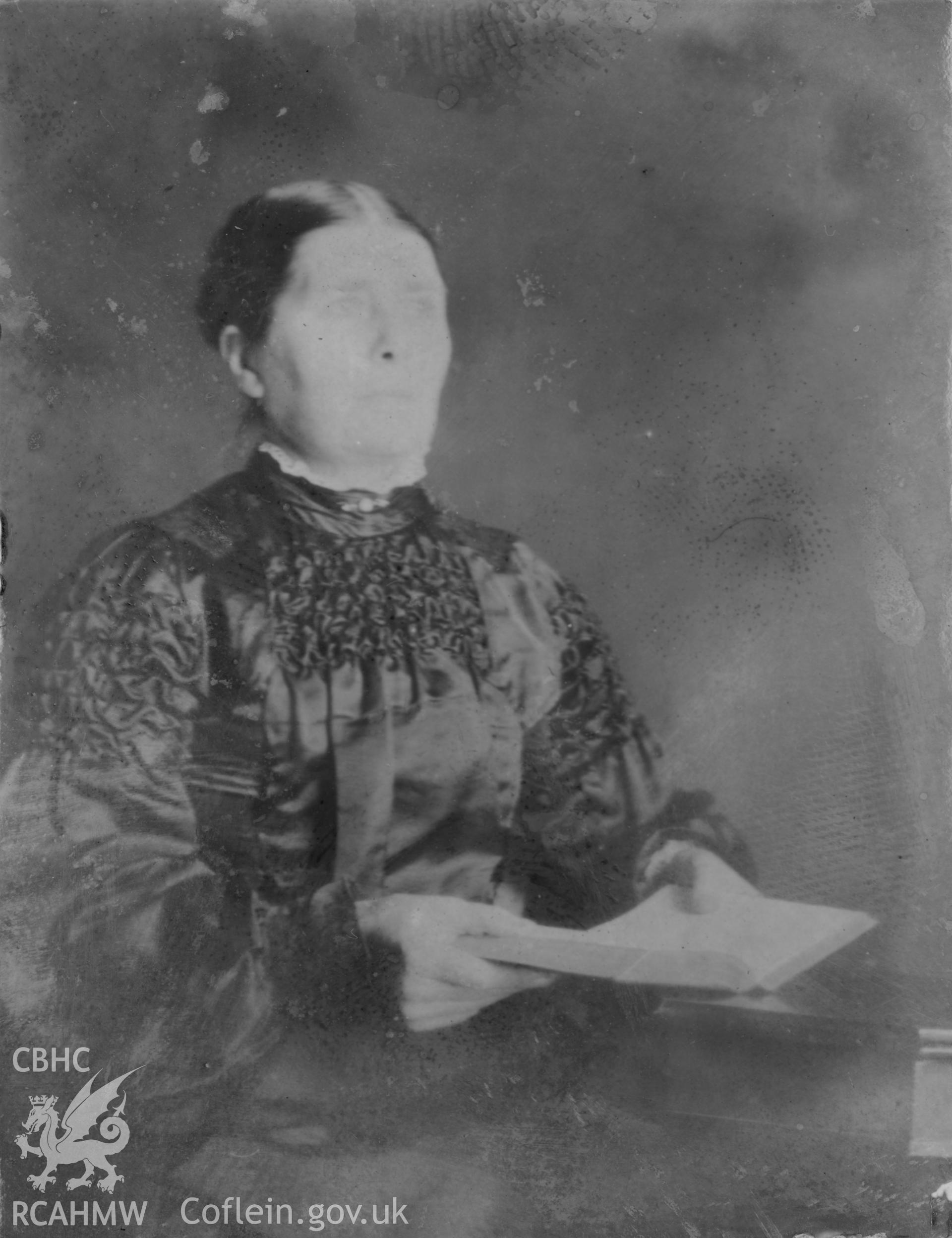 Portrait of a seated adult figure. Digitised from a photograph album showing views of Aberystwyth and District, produced by David John Saer, school teacher of Aberystwyth. Loaned for copying by Dr Alan Chamberlain.