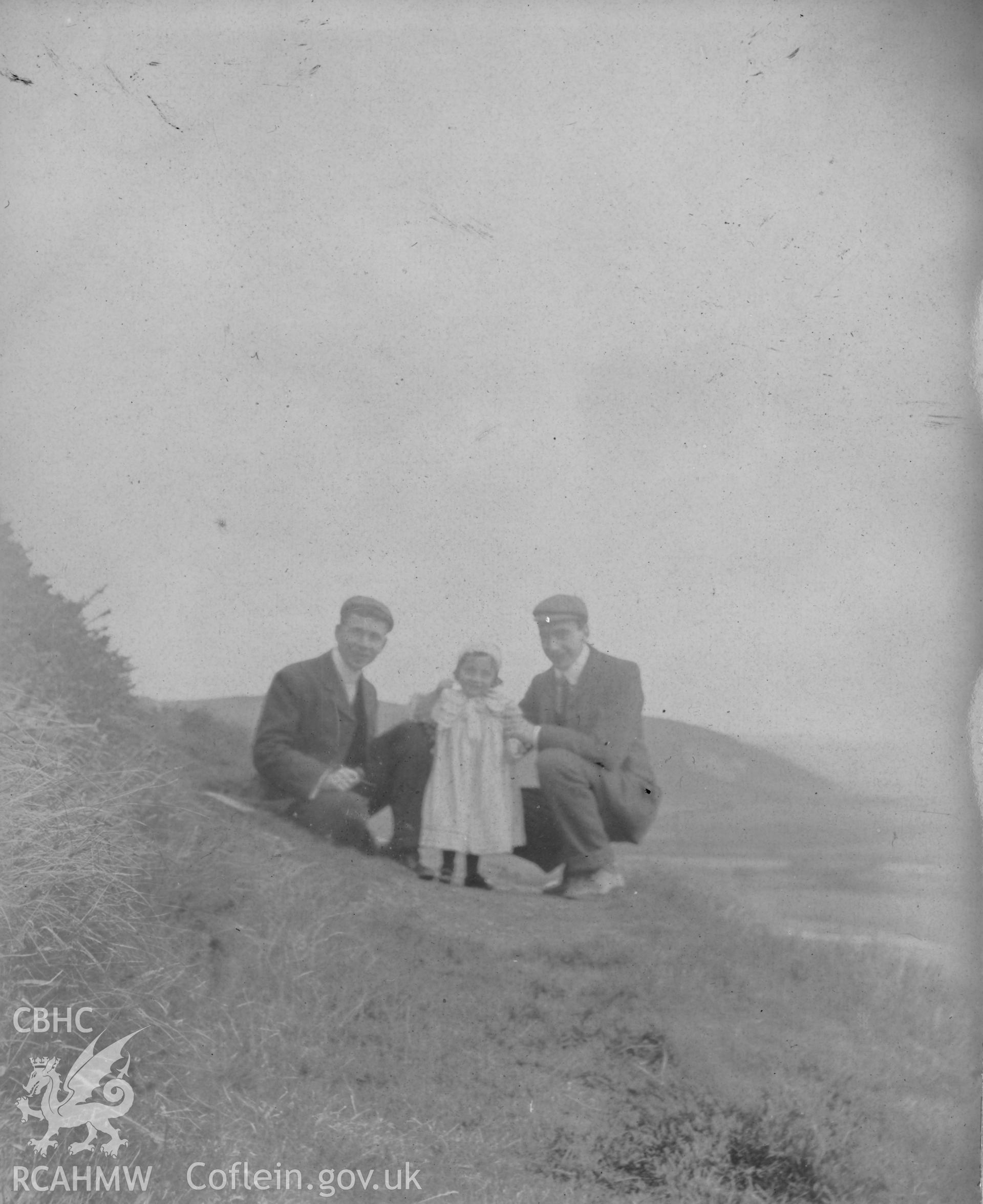 "On Pen Dinas path 1903". Photo of two adults and a small child. Digitised from a photograph album showing views of Aberystwyth and District, produced by David John Saer, school teacher of Aberystwyth. Loaned for copying by Dr Alan Chamberlain.