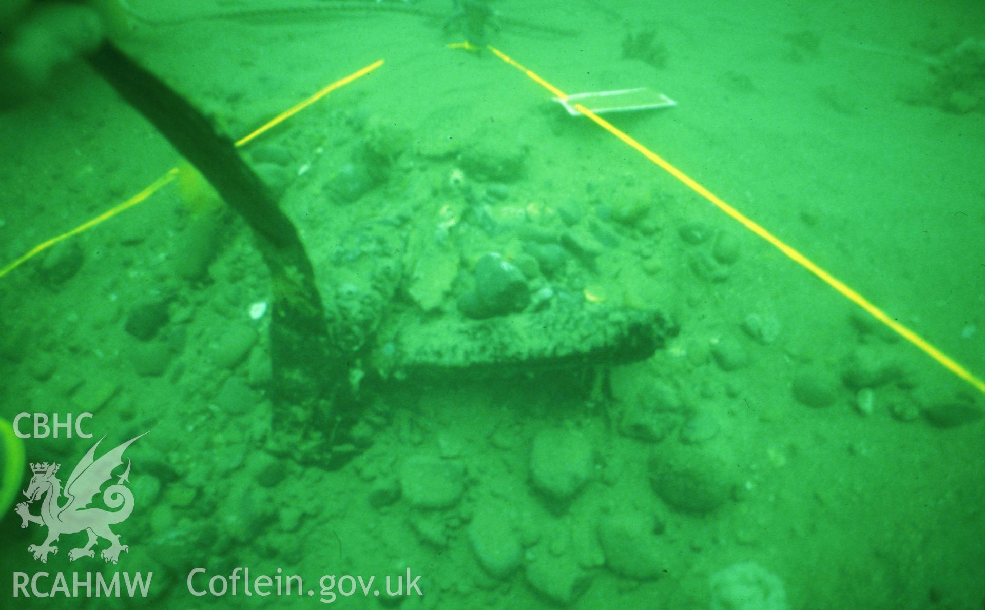 Colour slide. Strapping for wooden cladding of submarine standing proud above seabed.