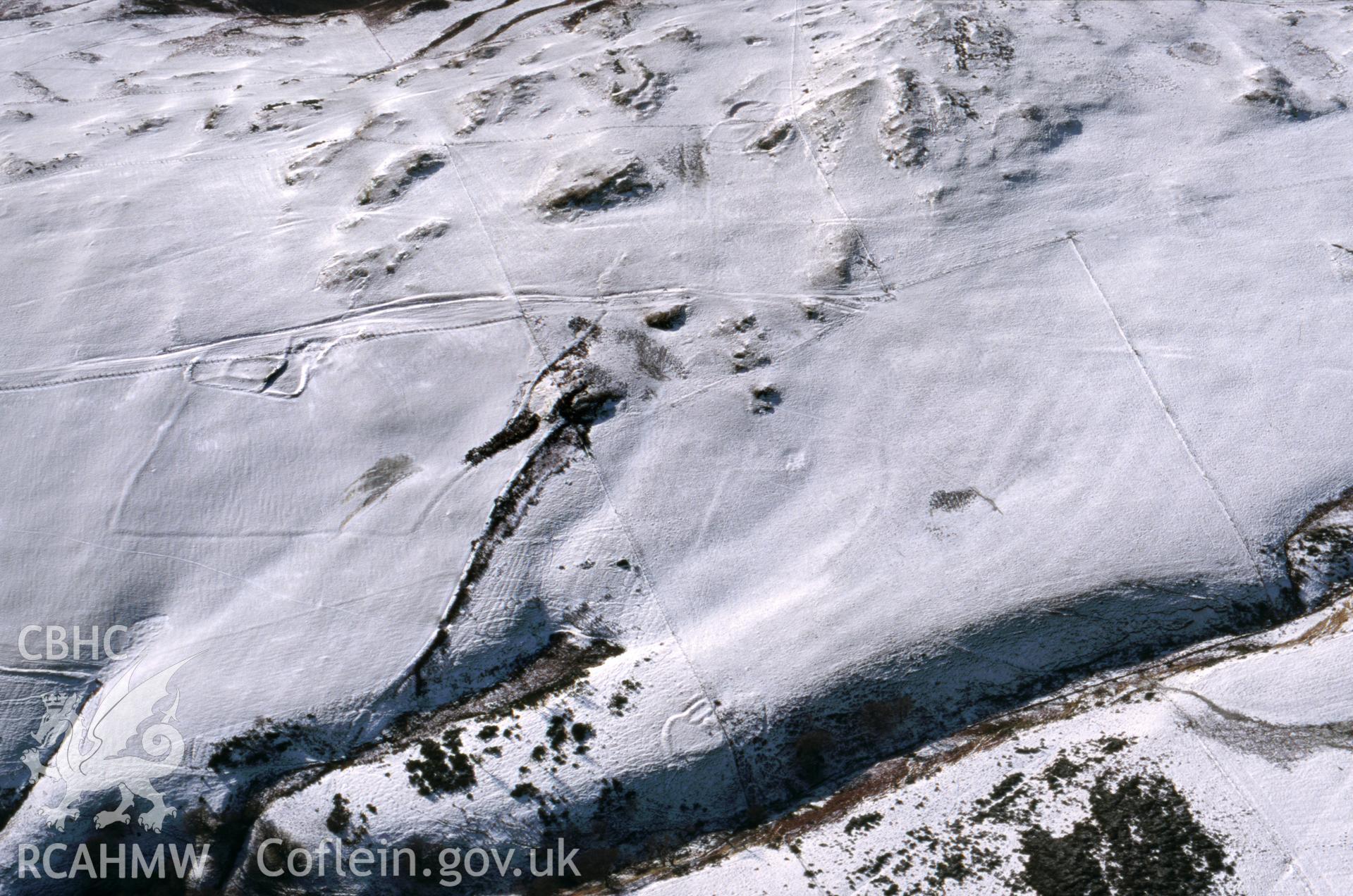 RCAHMW colour oblique aerial photograph of Cefn Golau & Cwm Sidwal, farmsteads and enclosures, under snow. Taken by Toby Driver on 31/01/2003