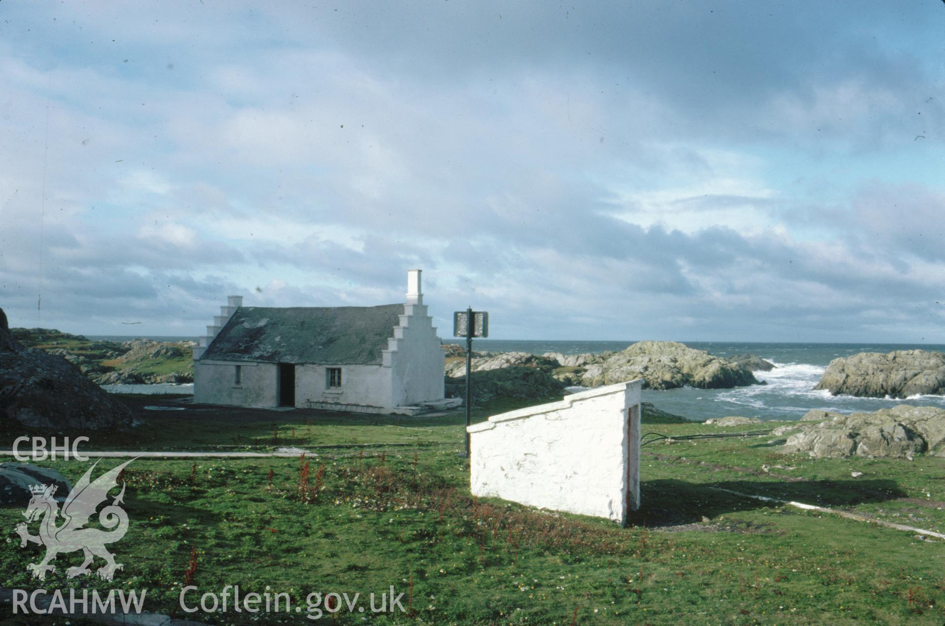 Colour slide showing eighteenth-century cottage and well.