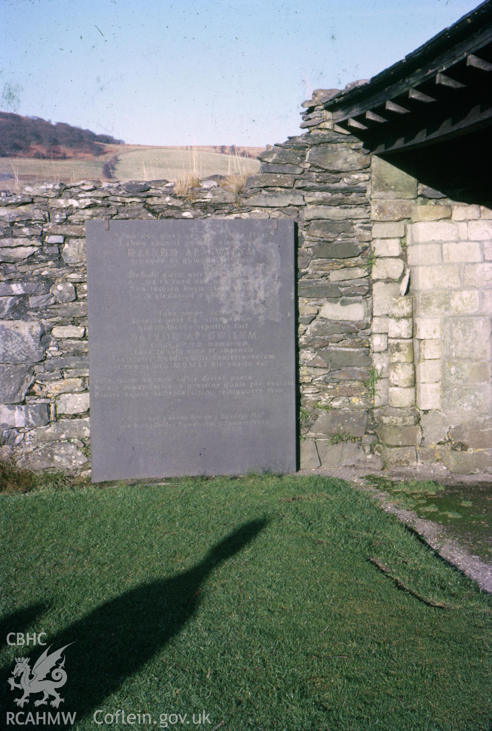 Colour slide showing memorial to Dafydd ap Gwilym in the churchyard at St Mary's Church.