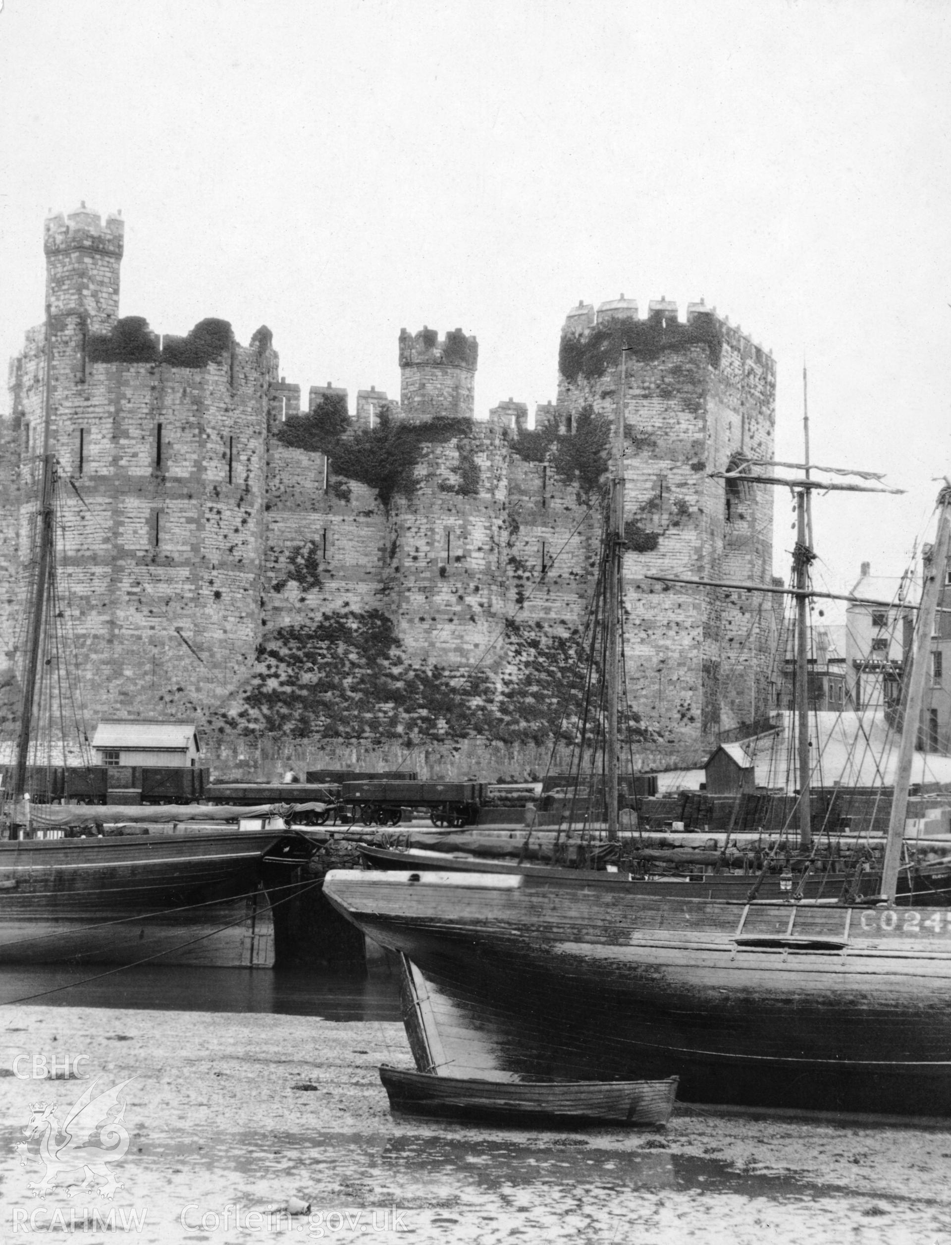 Caernarfon Castle; black and white photograph showing the castle also showing the eastern side of the entrance to the Seiont and coastal traders.