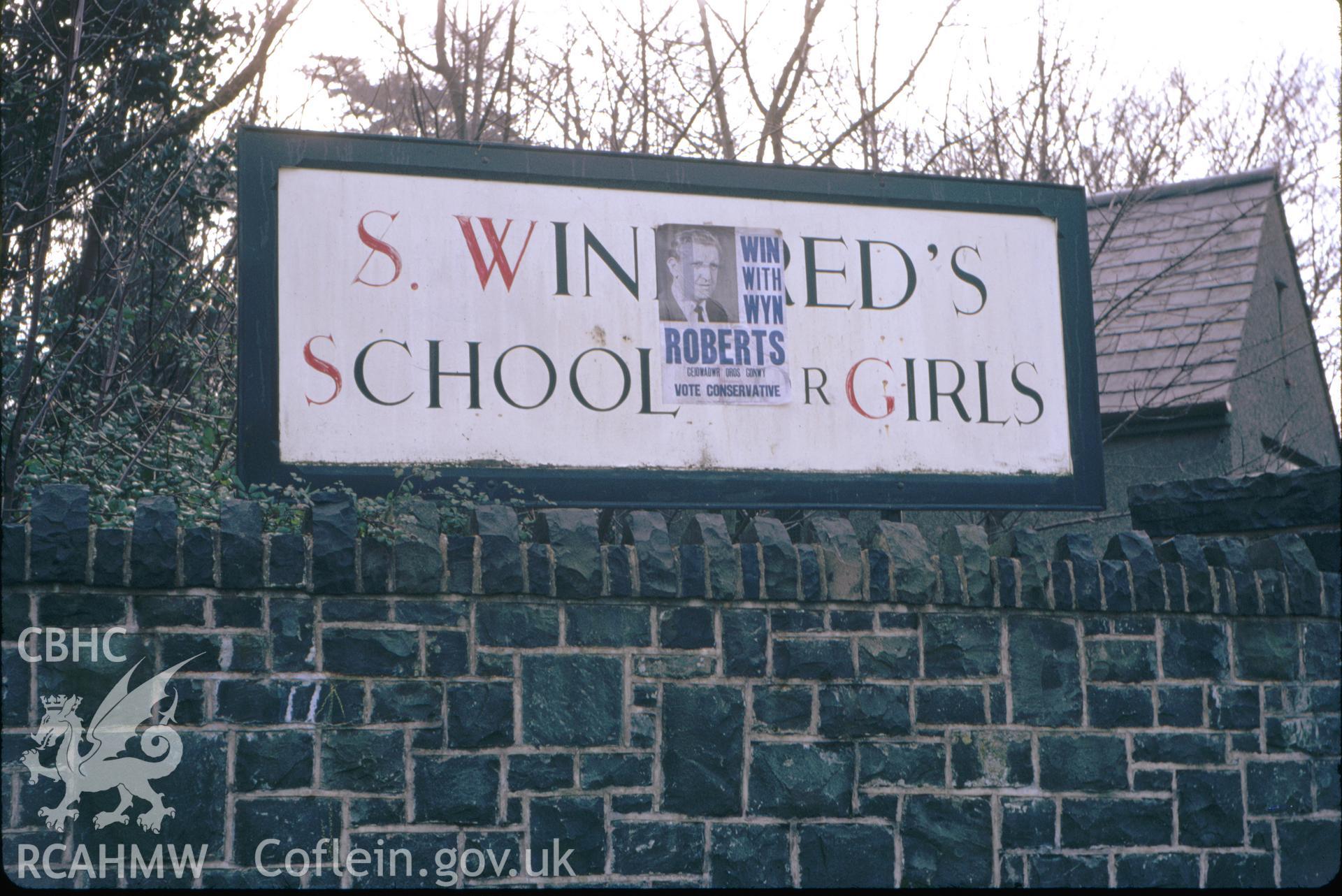 Colour slide showing school notice board outside the school and chapel.
