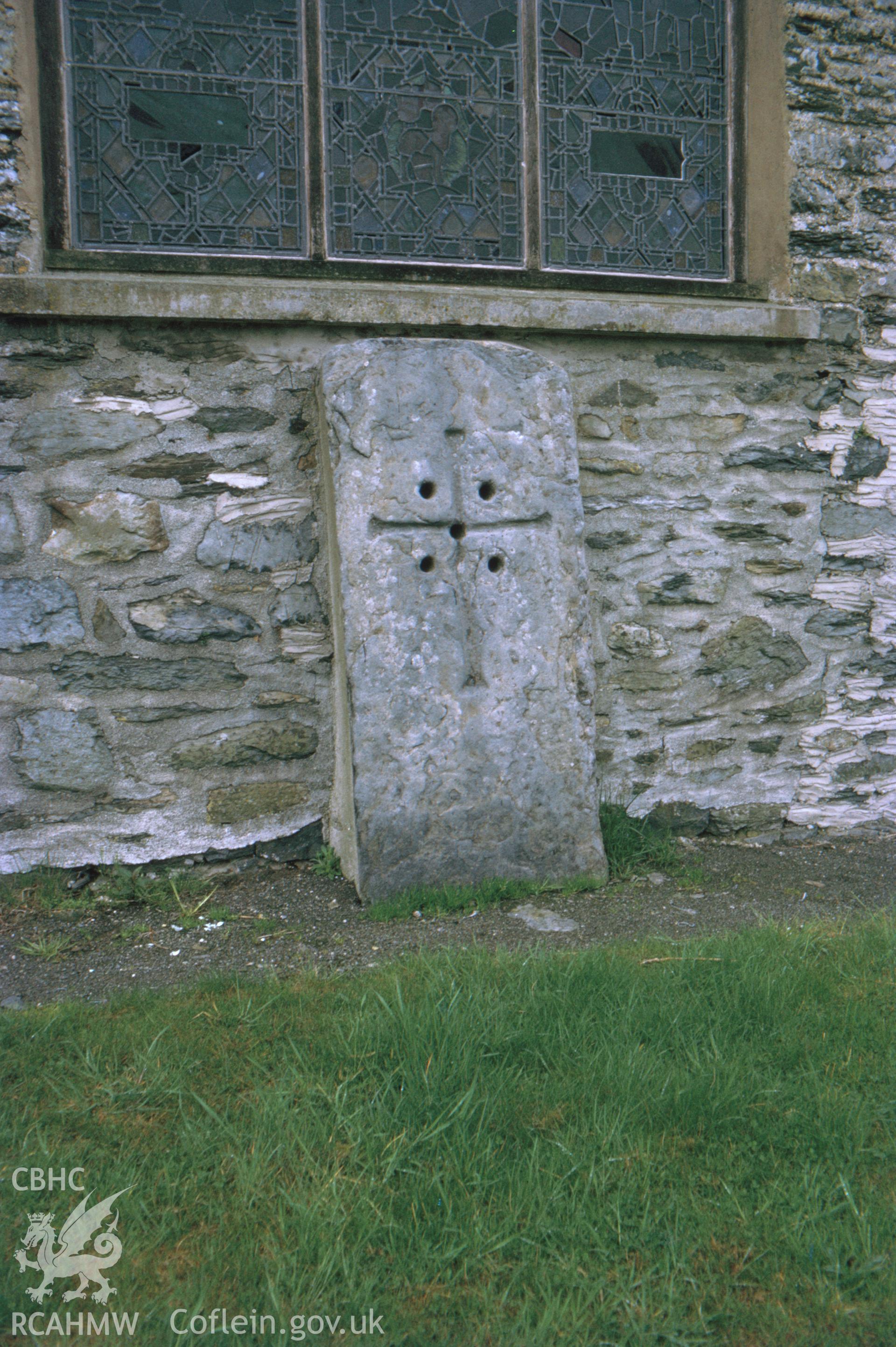 Colour slide showing early cross outside the east wall of the modern church.