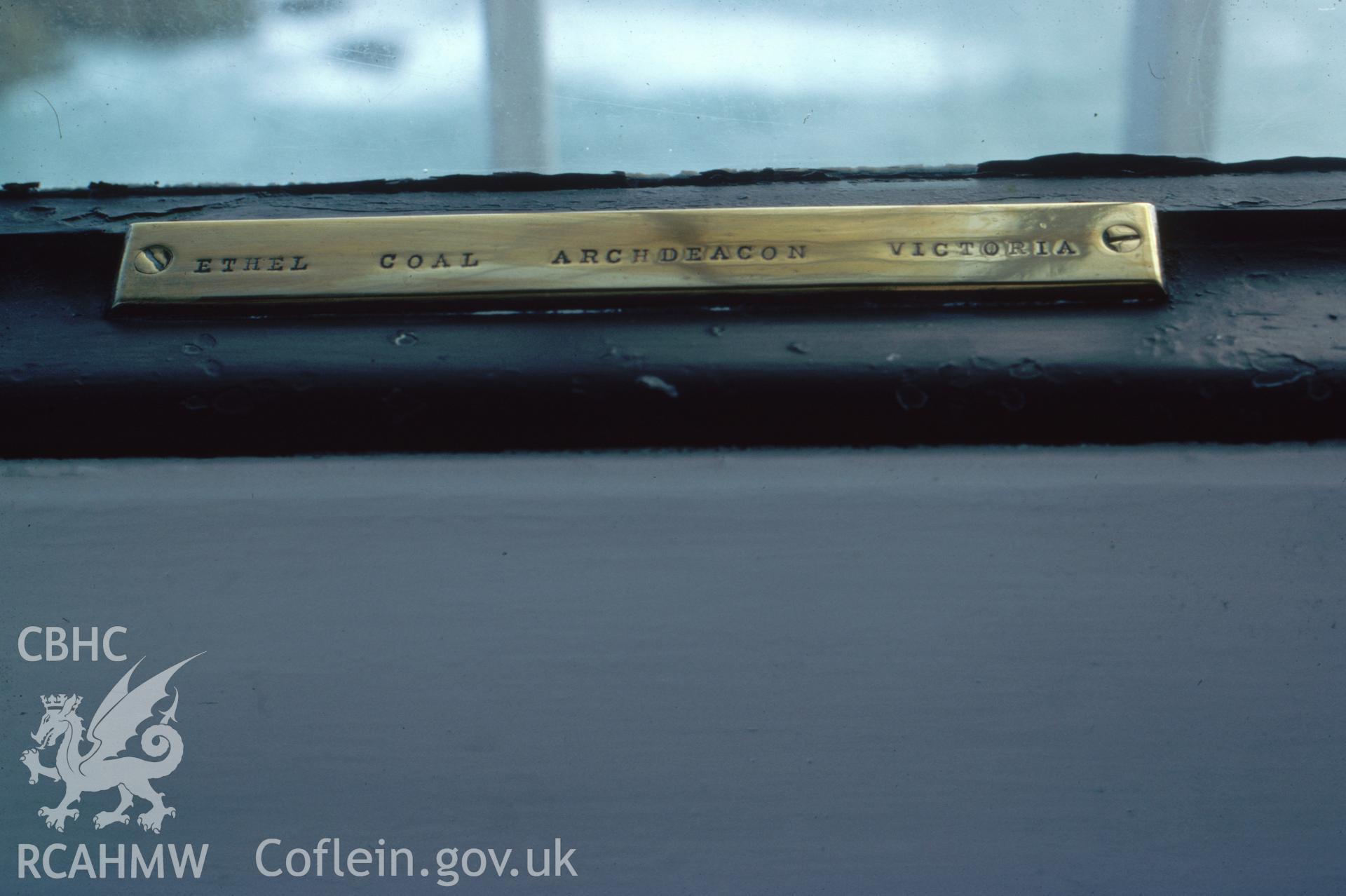 Colour slide, interior view showing a brass plate in the lantern of the lighthouse, displaying names of rocks off the island.