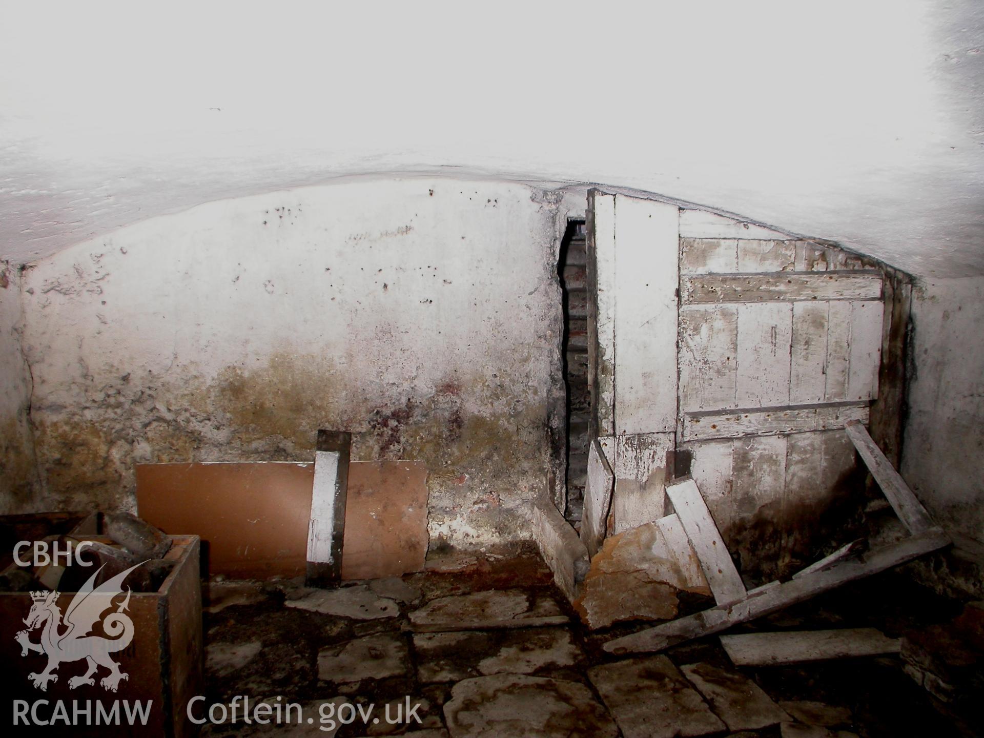 Cellar with internal stair doorway.