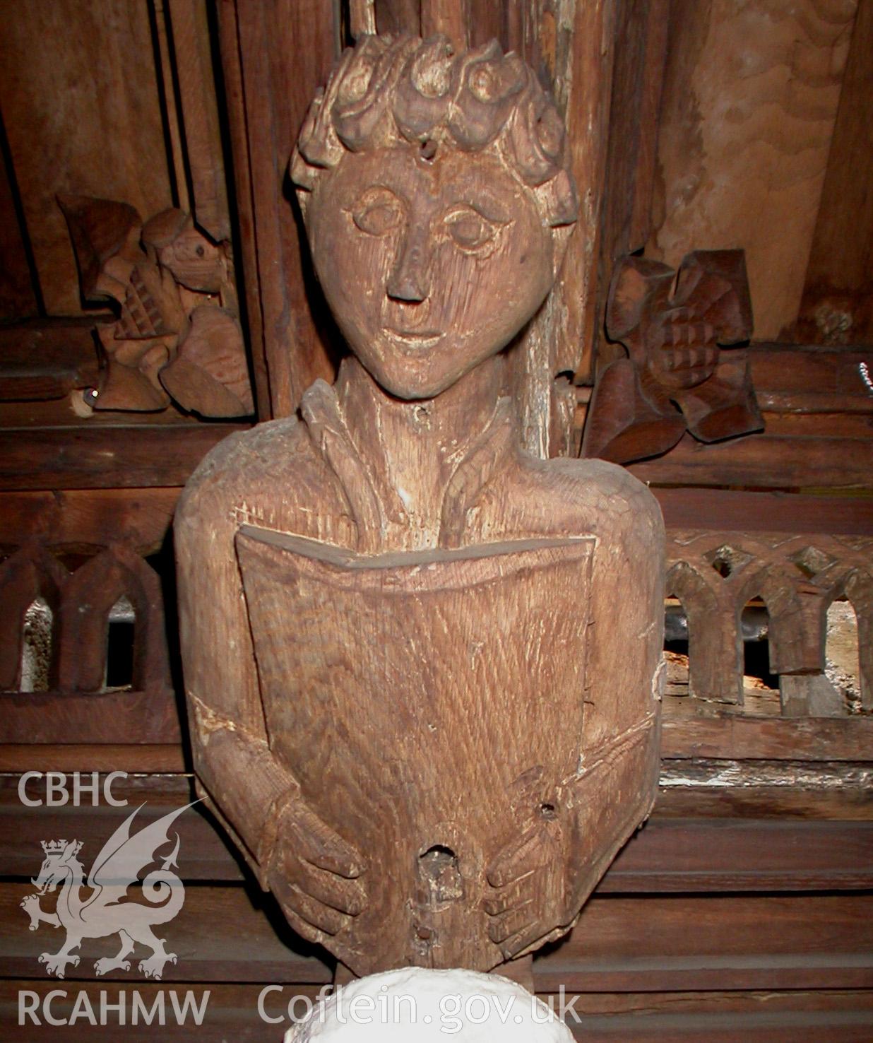 Carved wooden head between Trusses V & VI, North side.