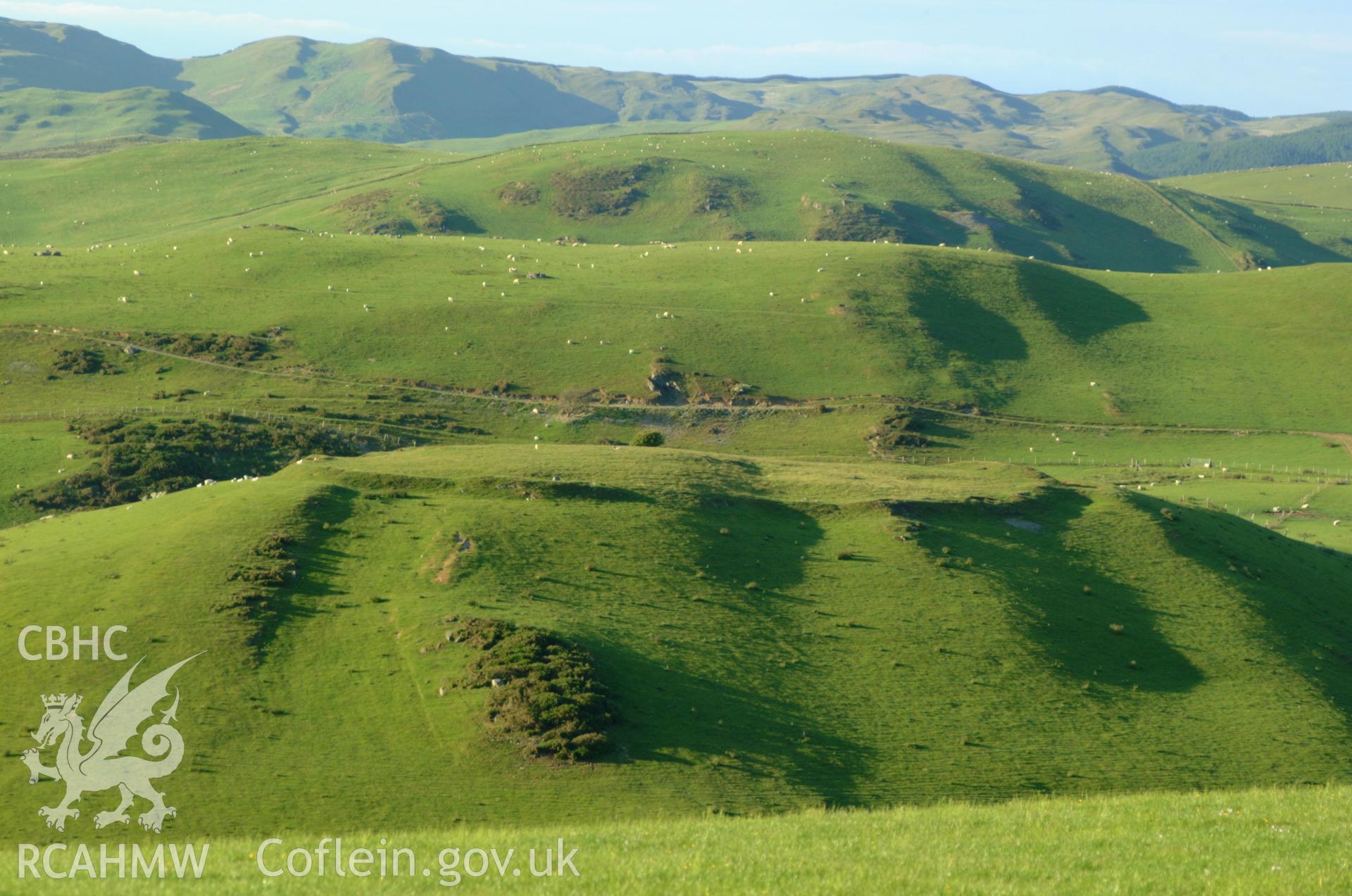 Pen y Castell hillfort, general view from south showing single rampart encircling hill.