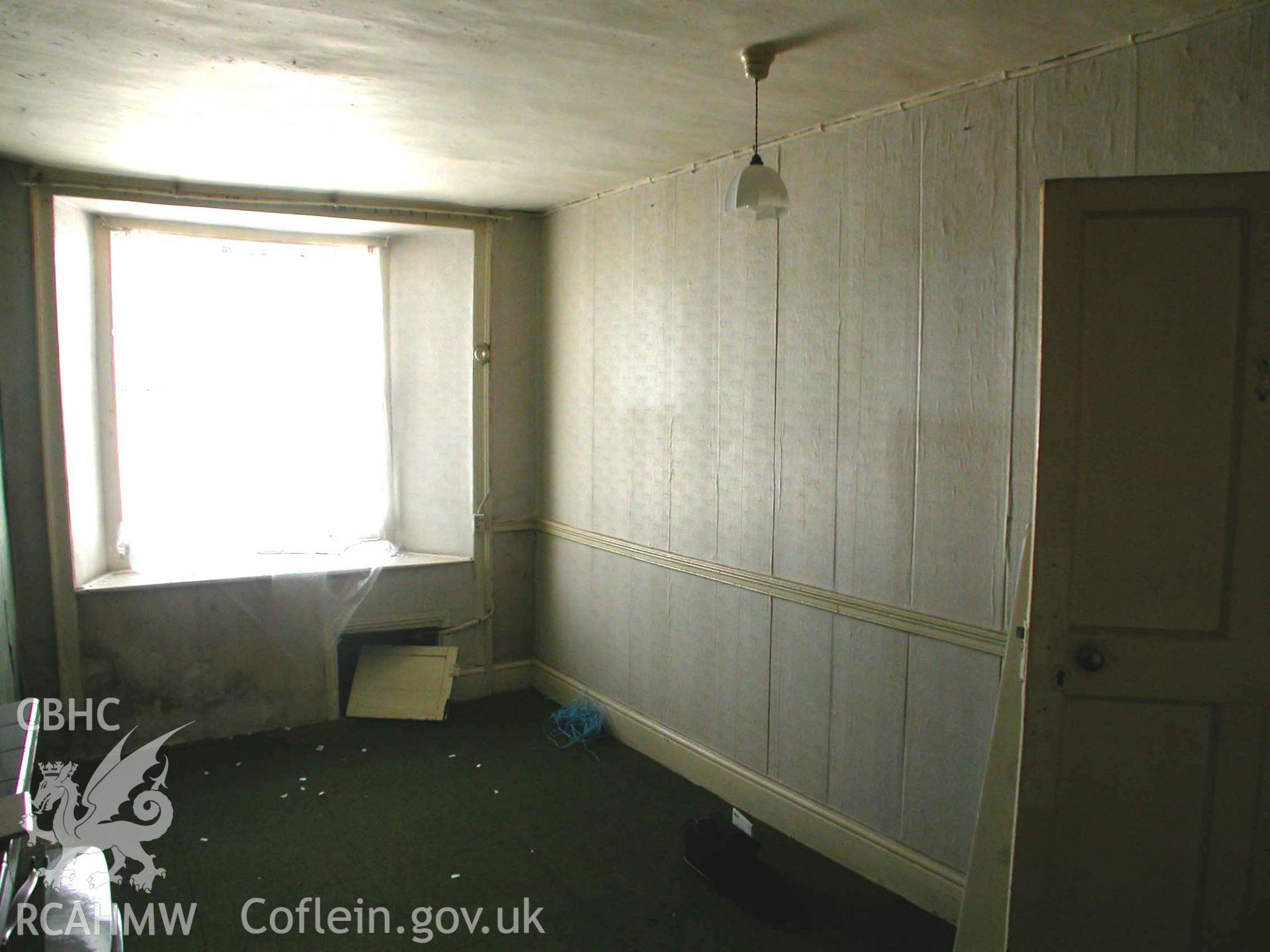 Room to west of hallway (Room 1), looking north-east, the window facing out onto the street.