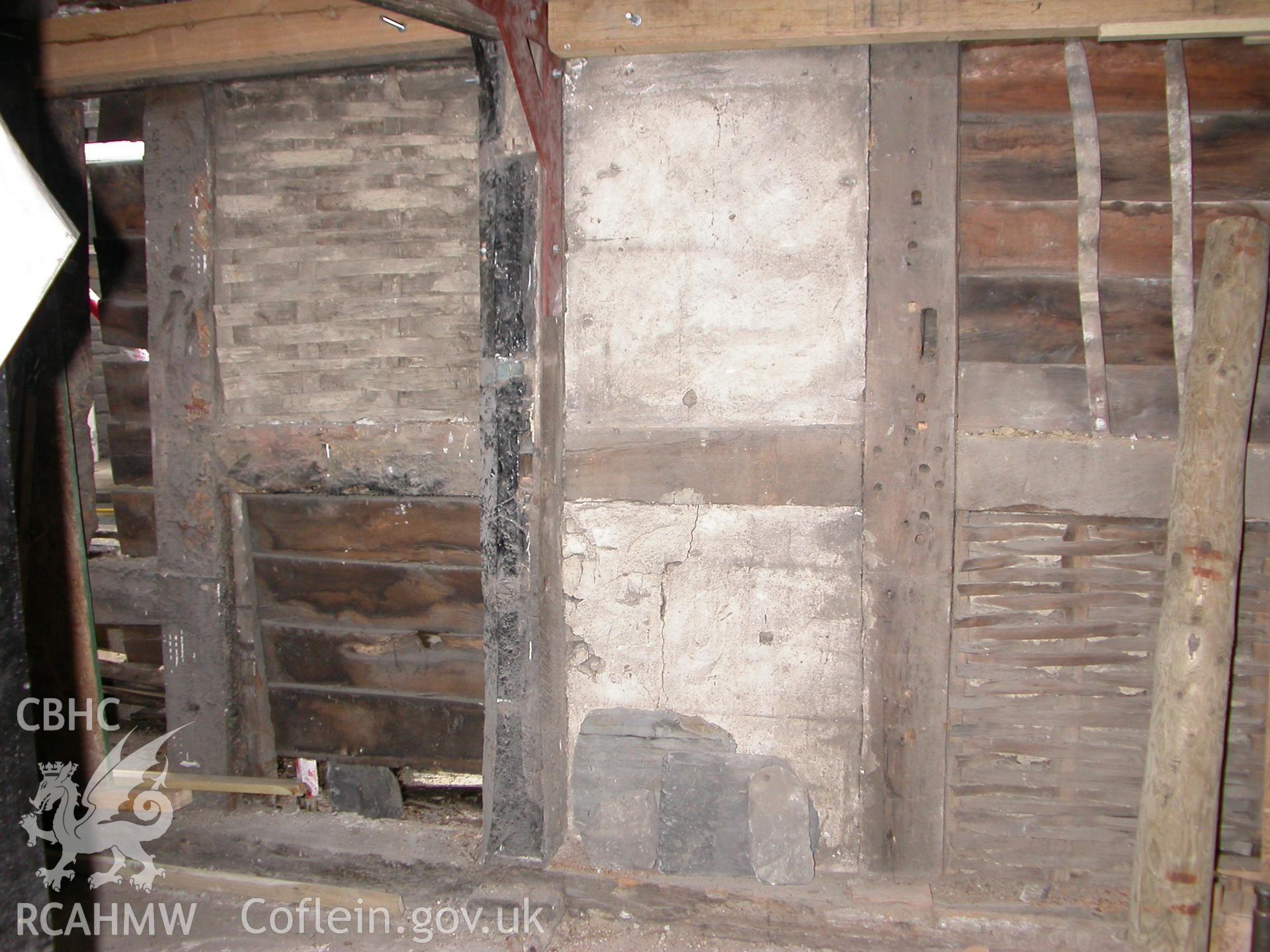 Interior of W wall showing fromer window frame evidence.