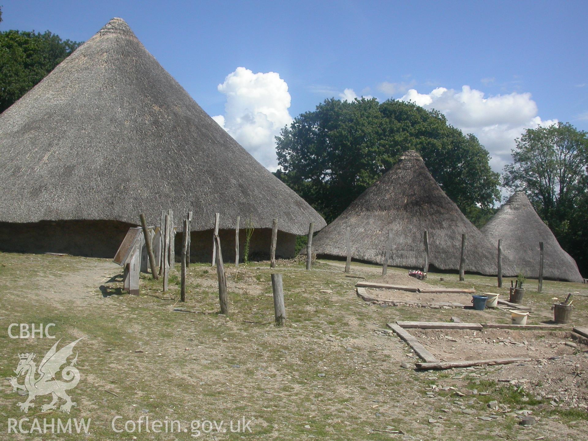 Three reconstructed roundhouses looking south-east with Chieftain's House in the front, then Earthwatch, then Old Roundhouse.