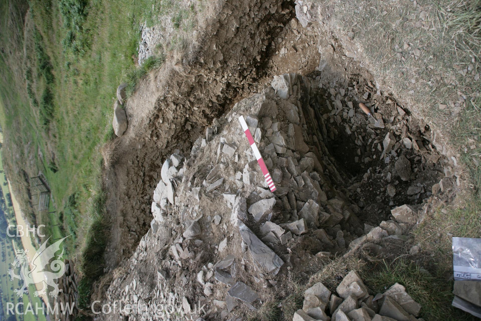 Darren; excavation of south terminal of main gateway with large quartz boulder in position, viewed from north-east, showing concavity or possible guardhouse.