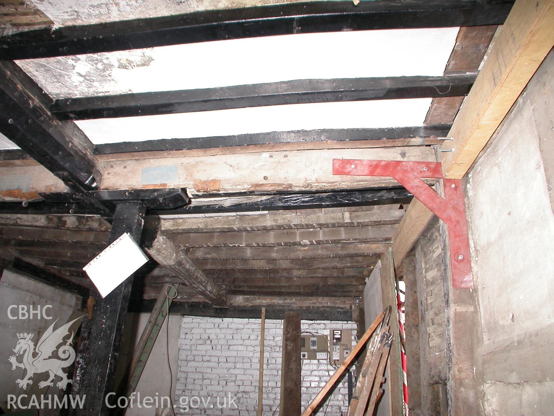 Ground-floor, at site of cross-partition under ceiling beam.