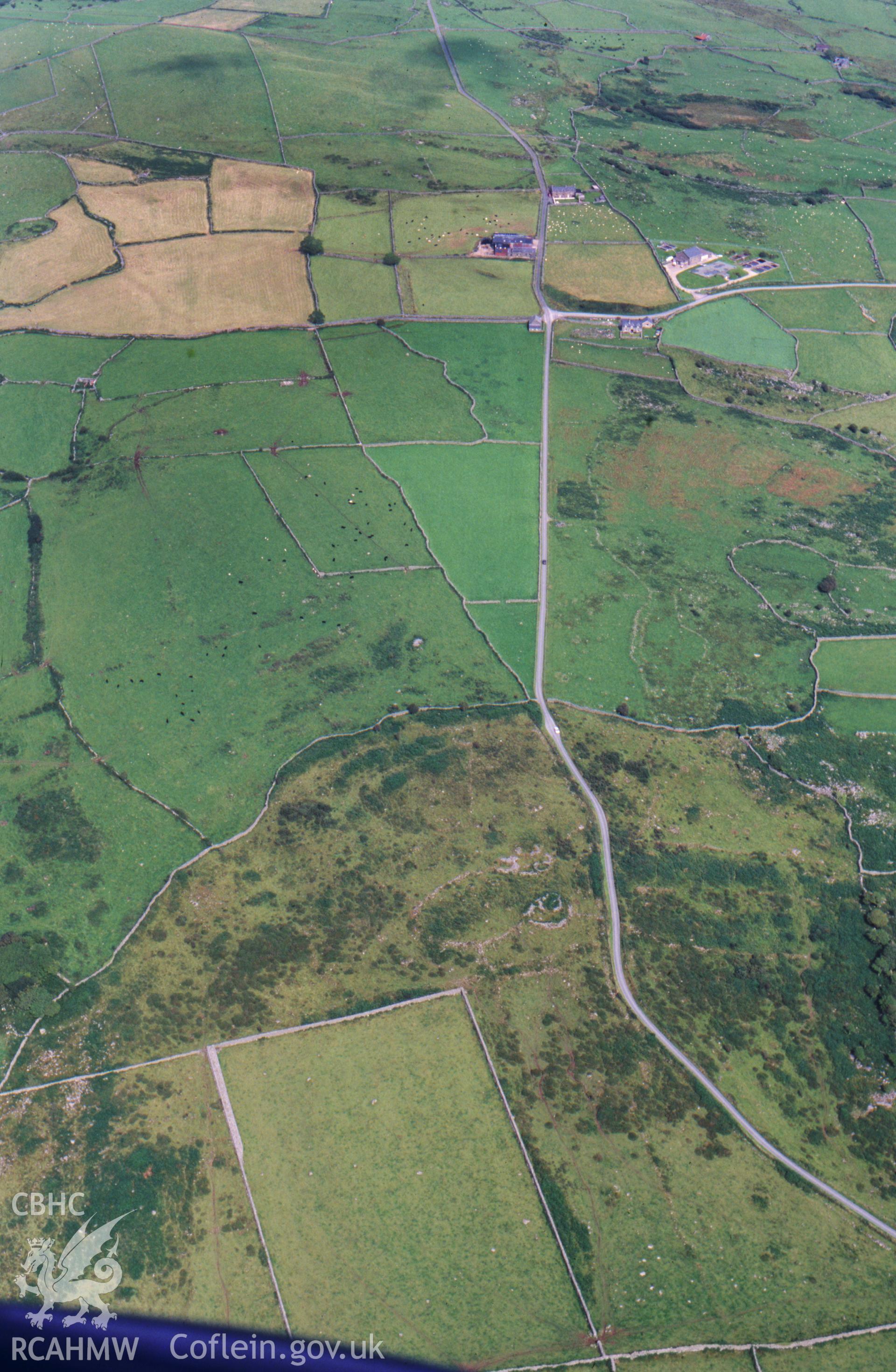 RCAHMW colour oblique aerial photograph of Muriau'r Gwyddelod, hut settlement and fields, very poor light. Taken by Toby Driver on 15/08/2002