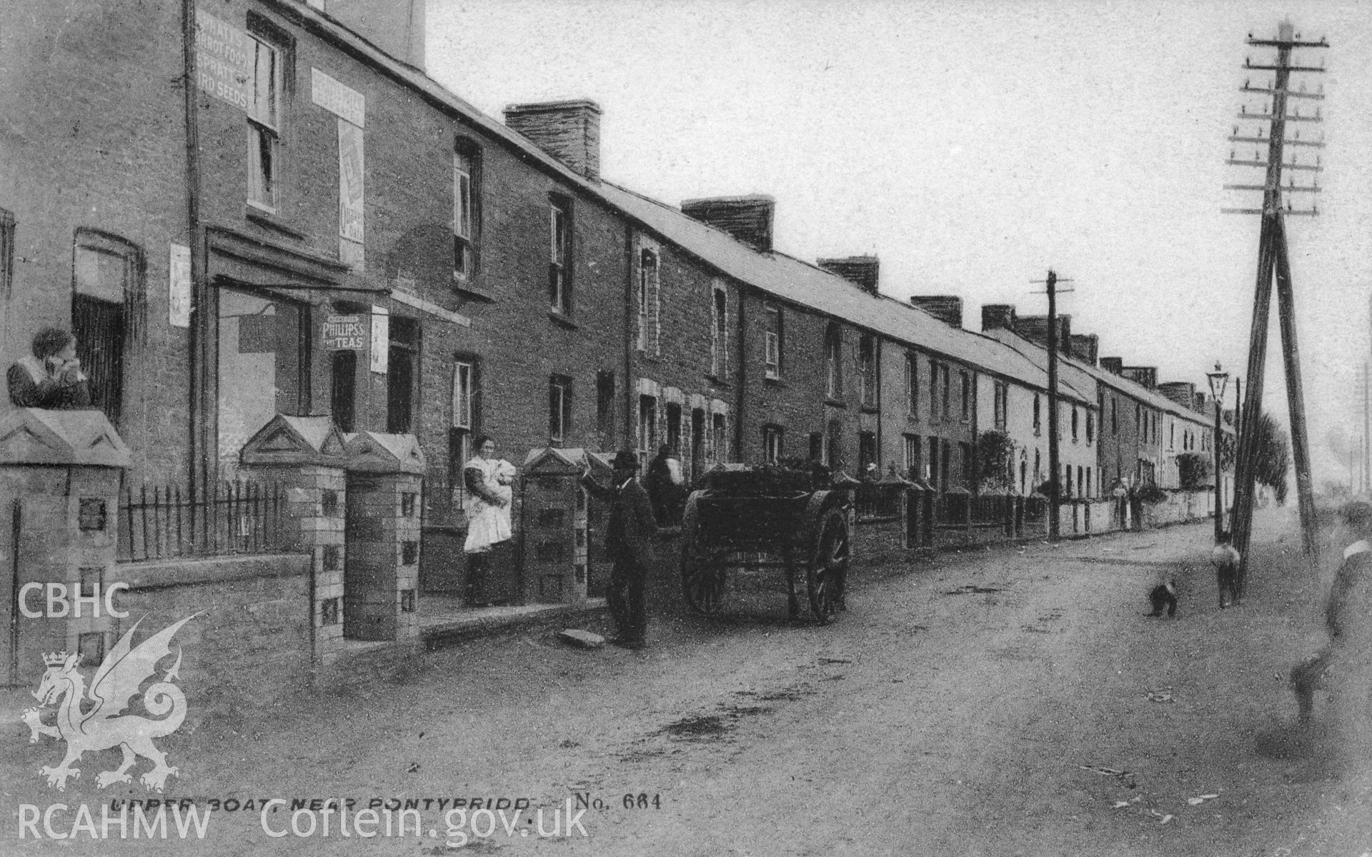 Postcard showing street in Upper Boat with shop, cart, figures and telegraph pole. Dated 1906.
