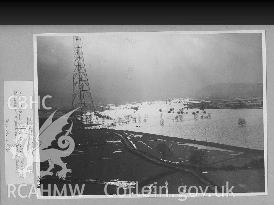 Black and white digital photograph of the river in full flood. The photograph is looking towards Welshpool from the centre mast.