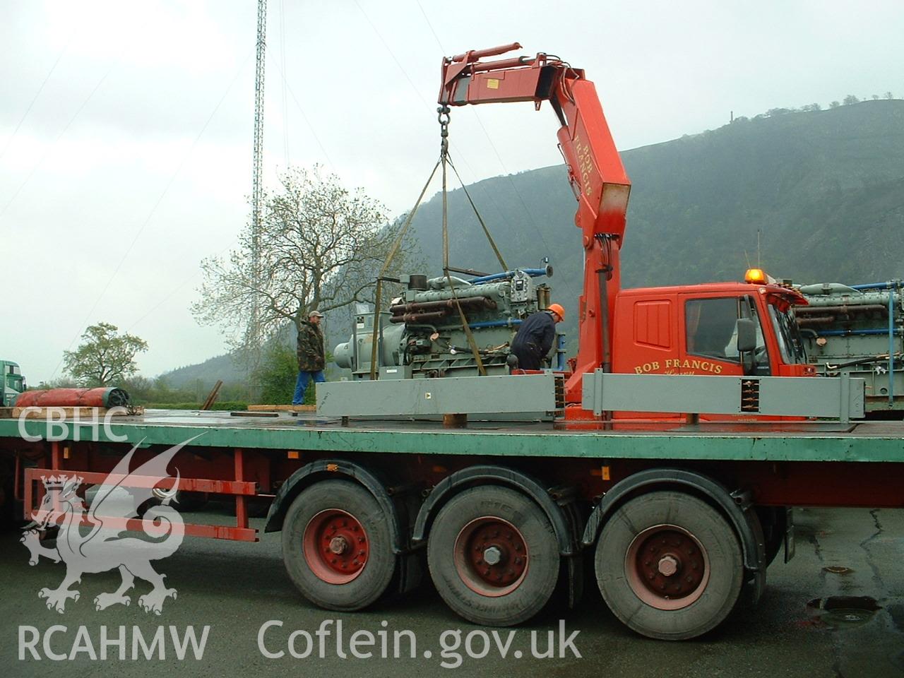 Colour digital photograph of engines being transported.