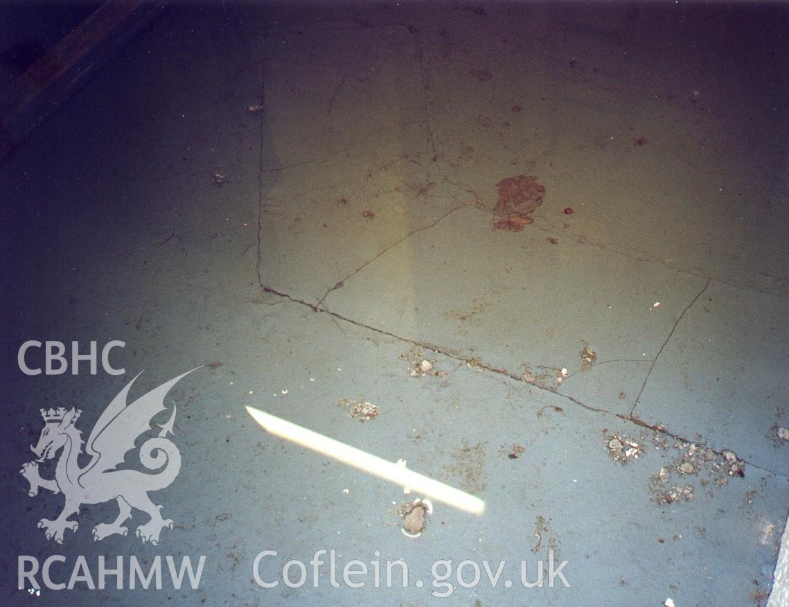 Colour digital photograph showing water leaking in through the MW floor.