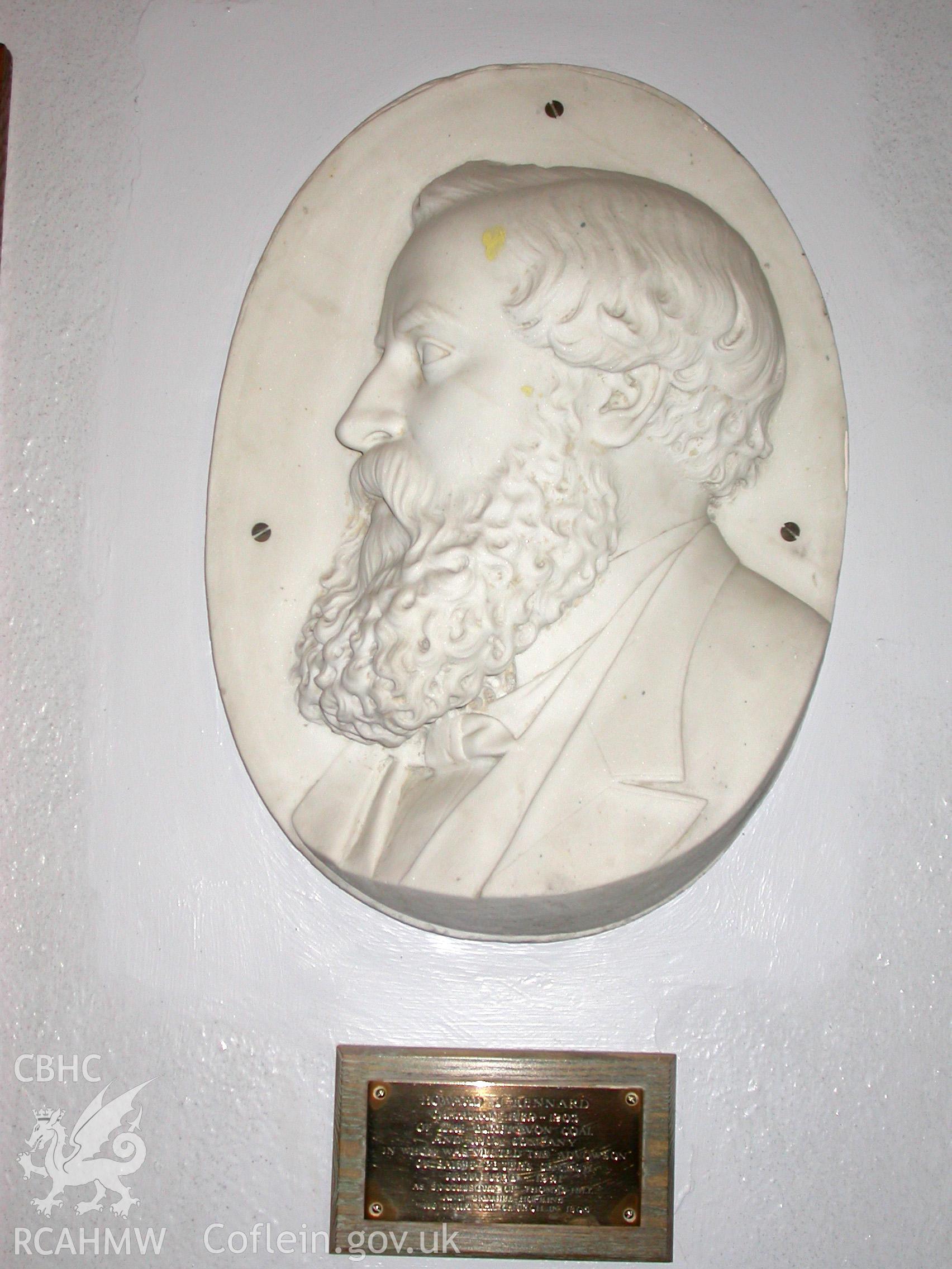 Brass plaque under the wall-mounted profile bust of Howard Kennard.