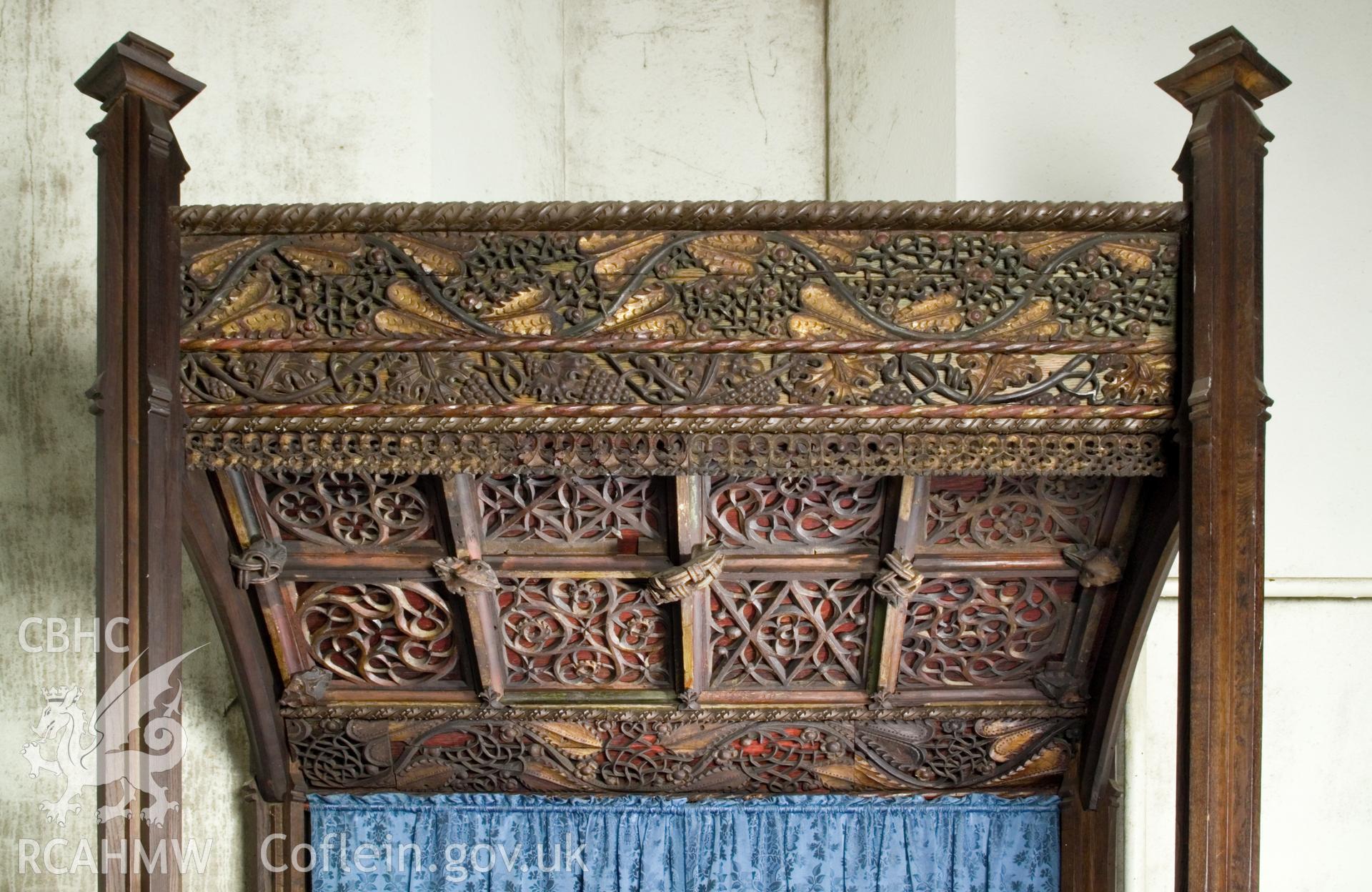 Ornate carved and painted altar canopy.