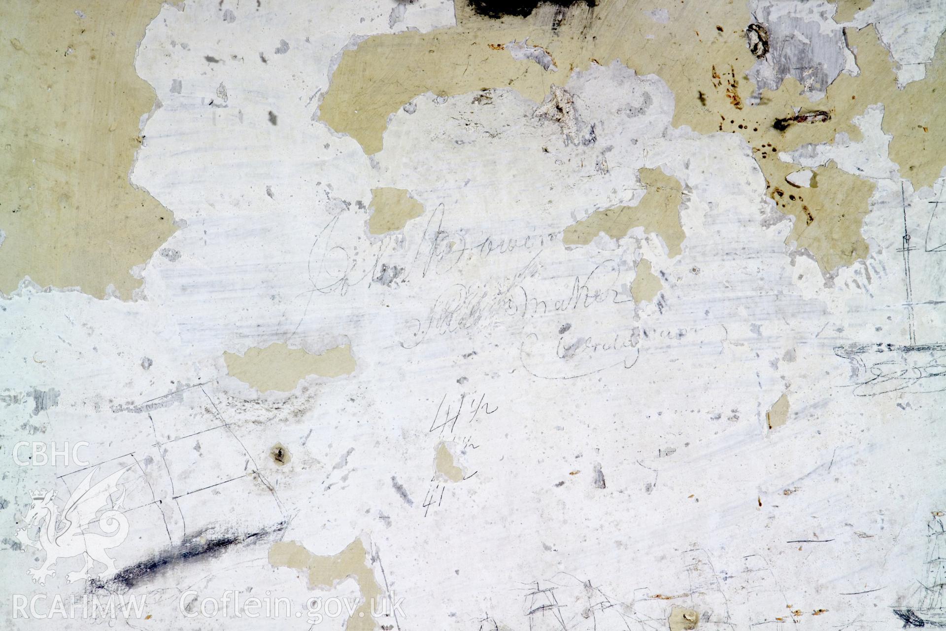 South wall, lefthand panel. Detail of graffitti.