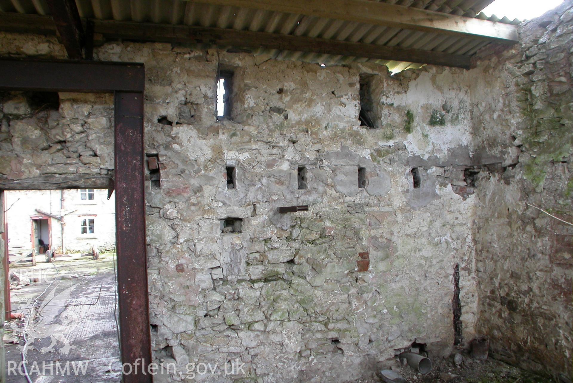 Interior of barn at S-E doorway, showing rebates in wall for later joist floor.