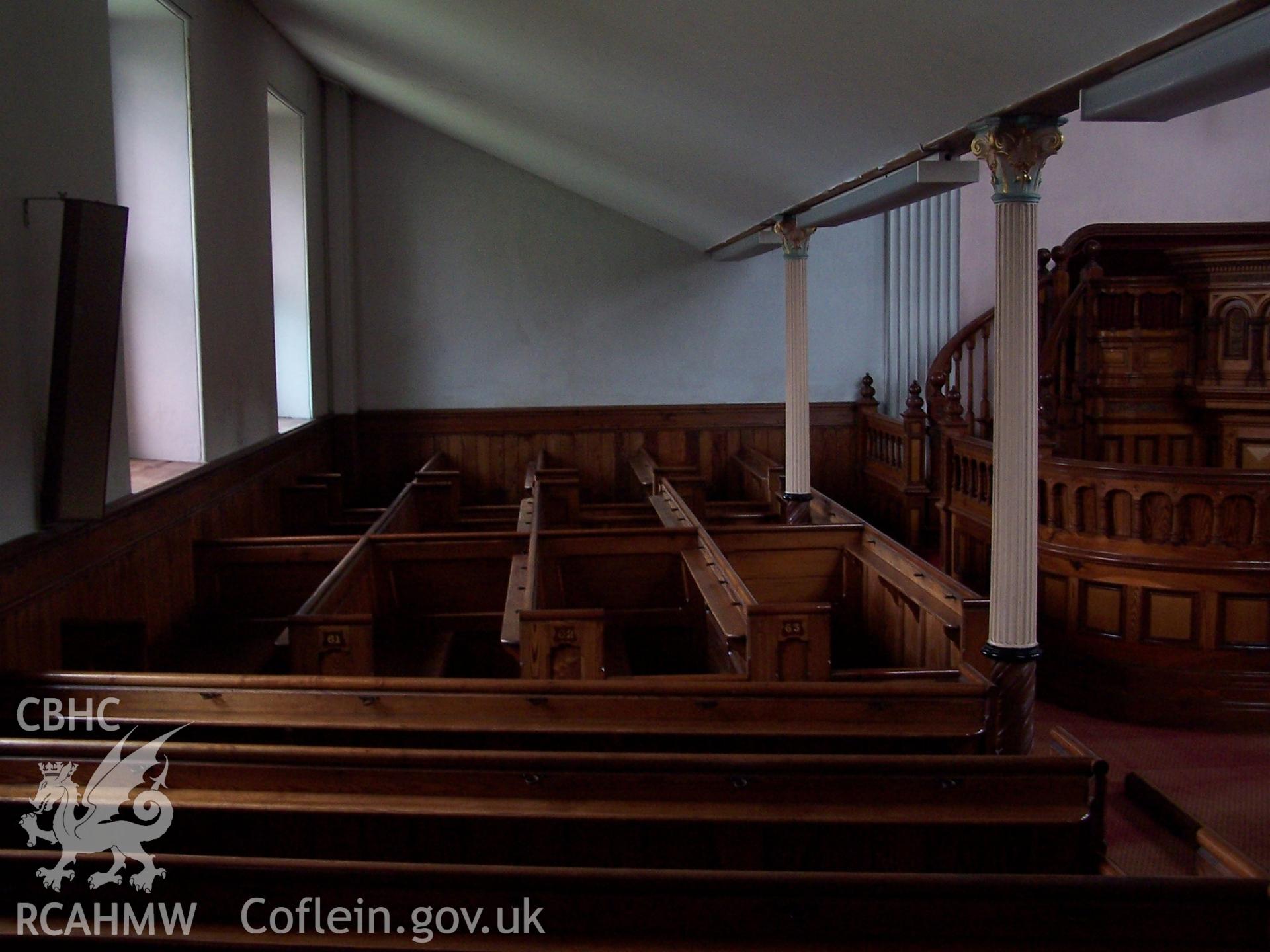 Chapel: Interior - left-hand pew blocks beneath gallery overhang.