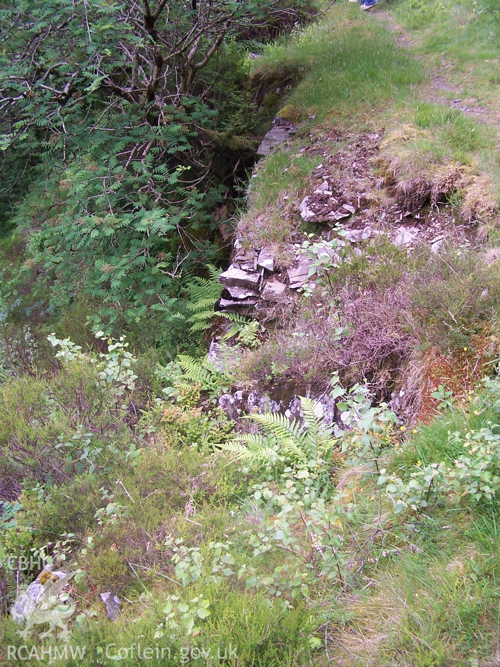 Tramway formation supported by revetment walling.