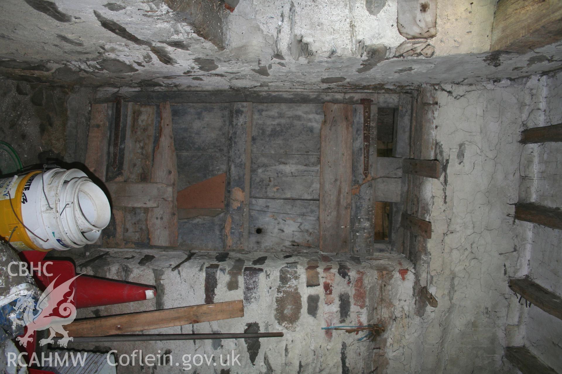 Interior, tack-room doorway to stable S cross-wall.