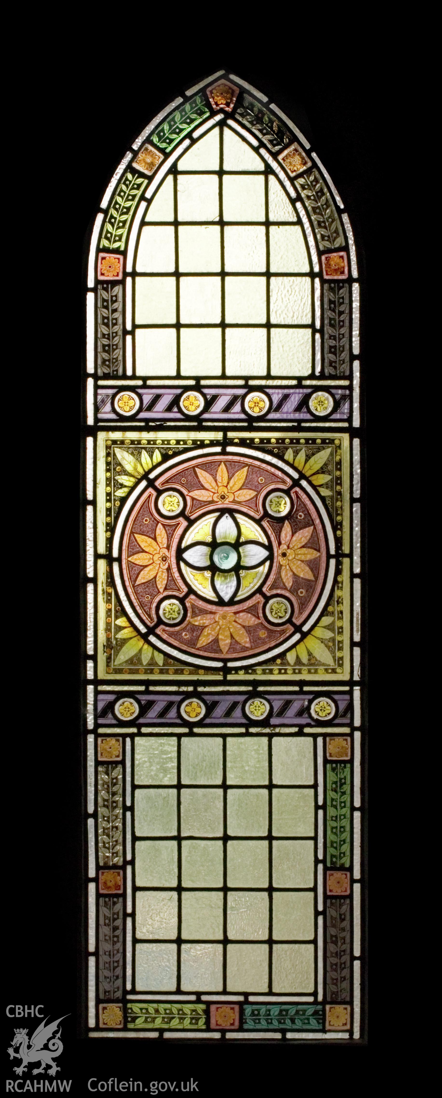 Small stained glass window at front.
