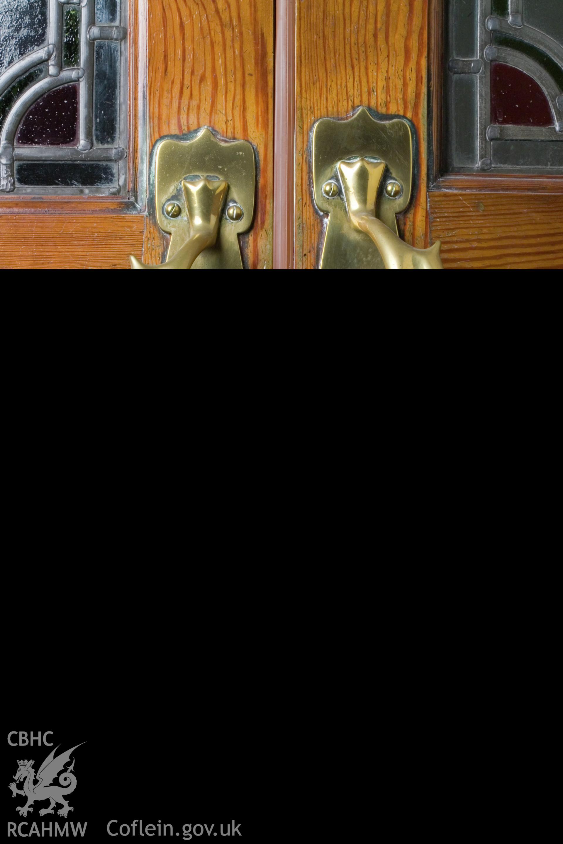Brass doorhandles on reduced stile door.