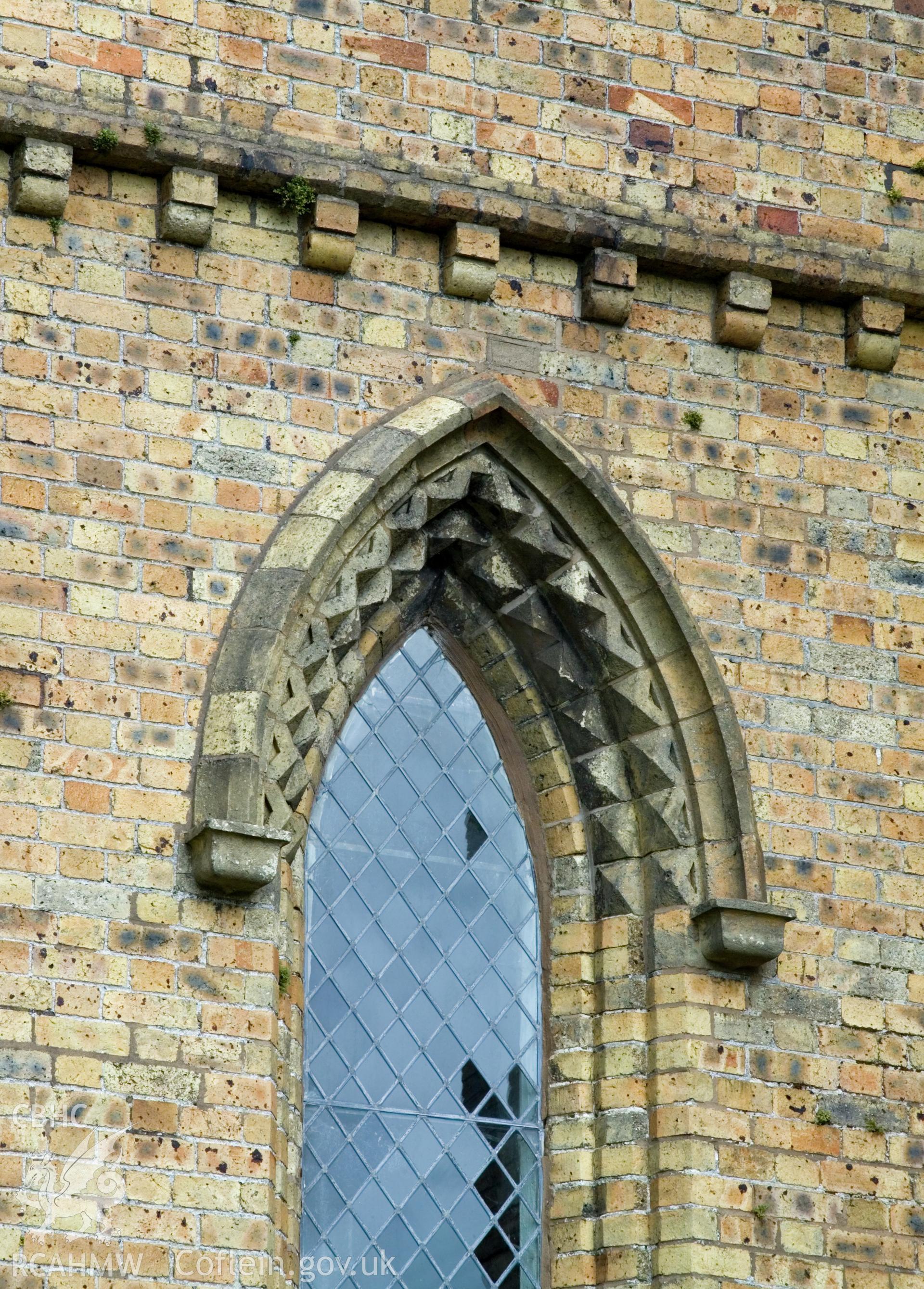 Equilateral window arch with decorative brick chevron moulding.