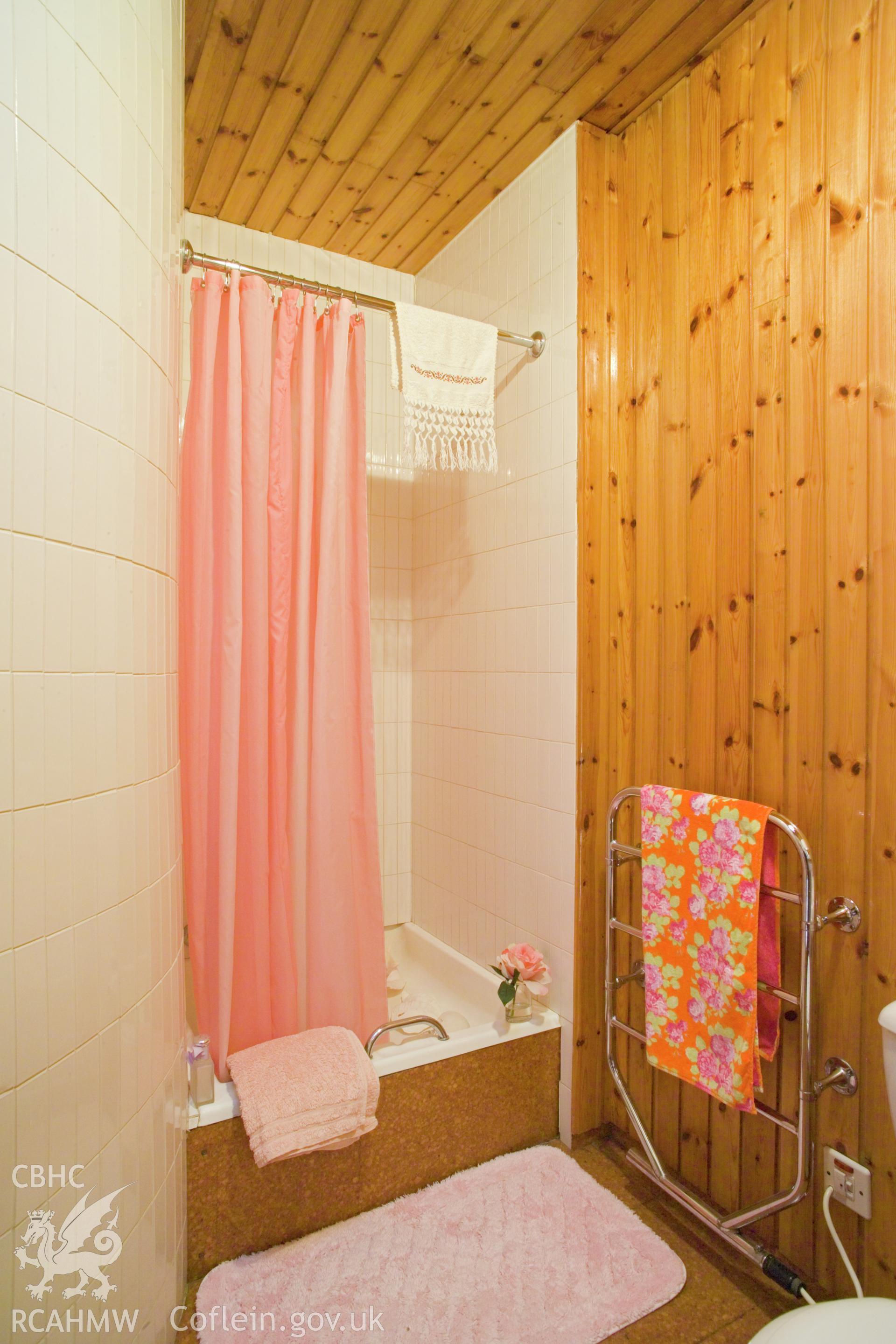 Shower room, staircase well outer wall to left.
