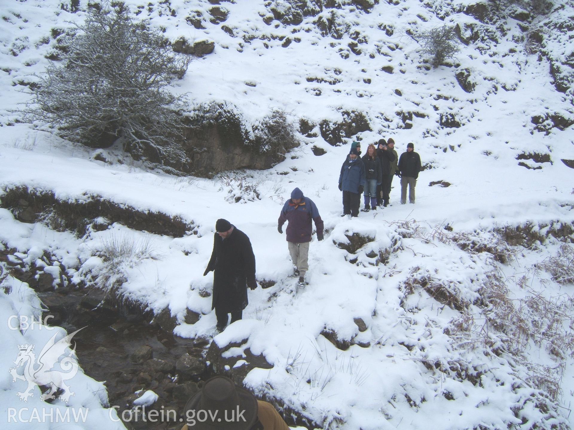 Bristol University Landscape Archaeology students crossing collapsed Nant Llanwenarth Culvert from E in snow.