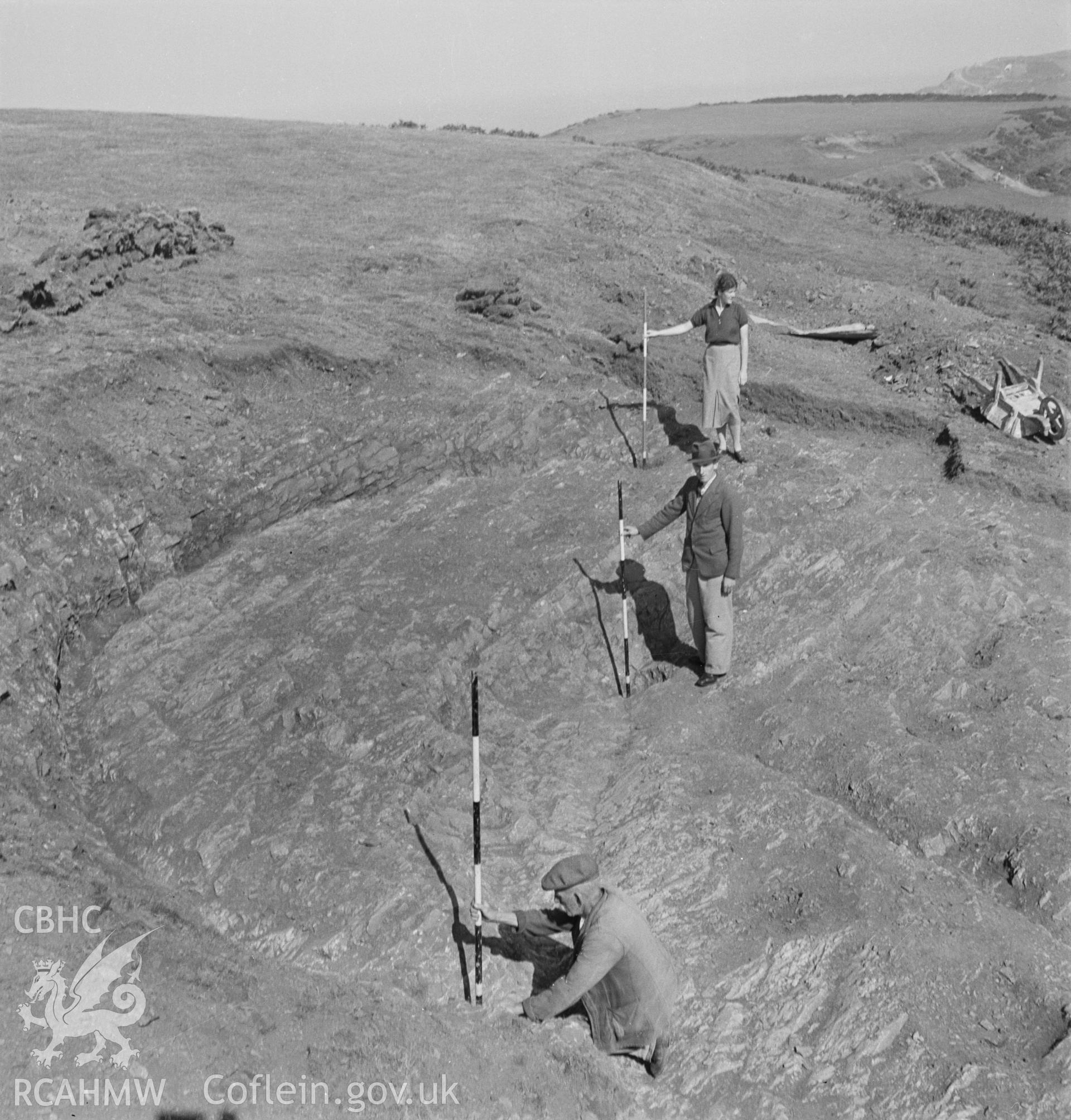 Excavation detail showing member of excavation team at work