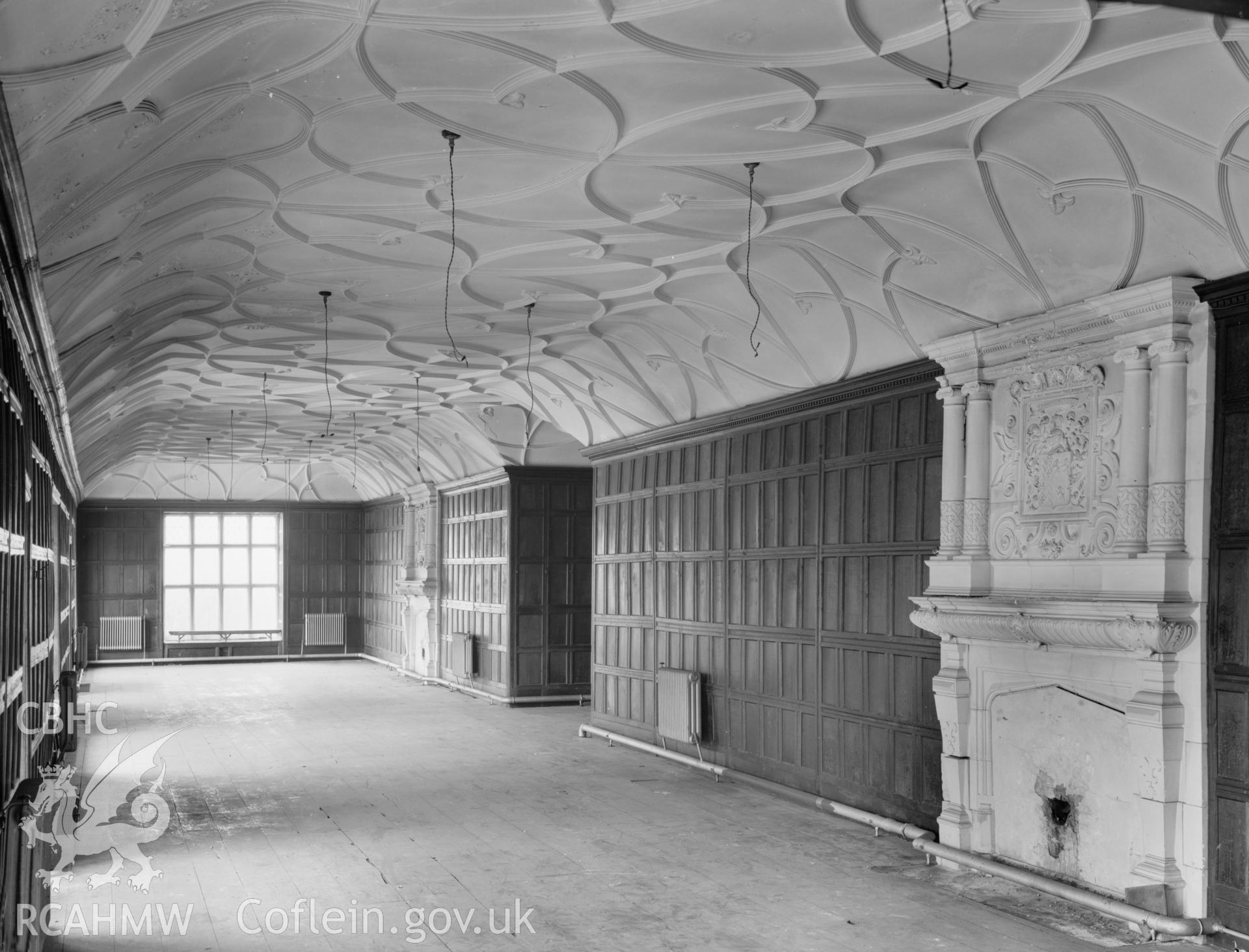 Interior view of Aberpergwn House showing hall with fireplace and decorated ceiling, taken 13.08.65.